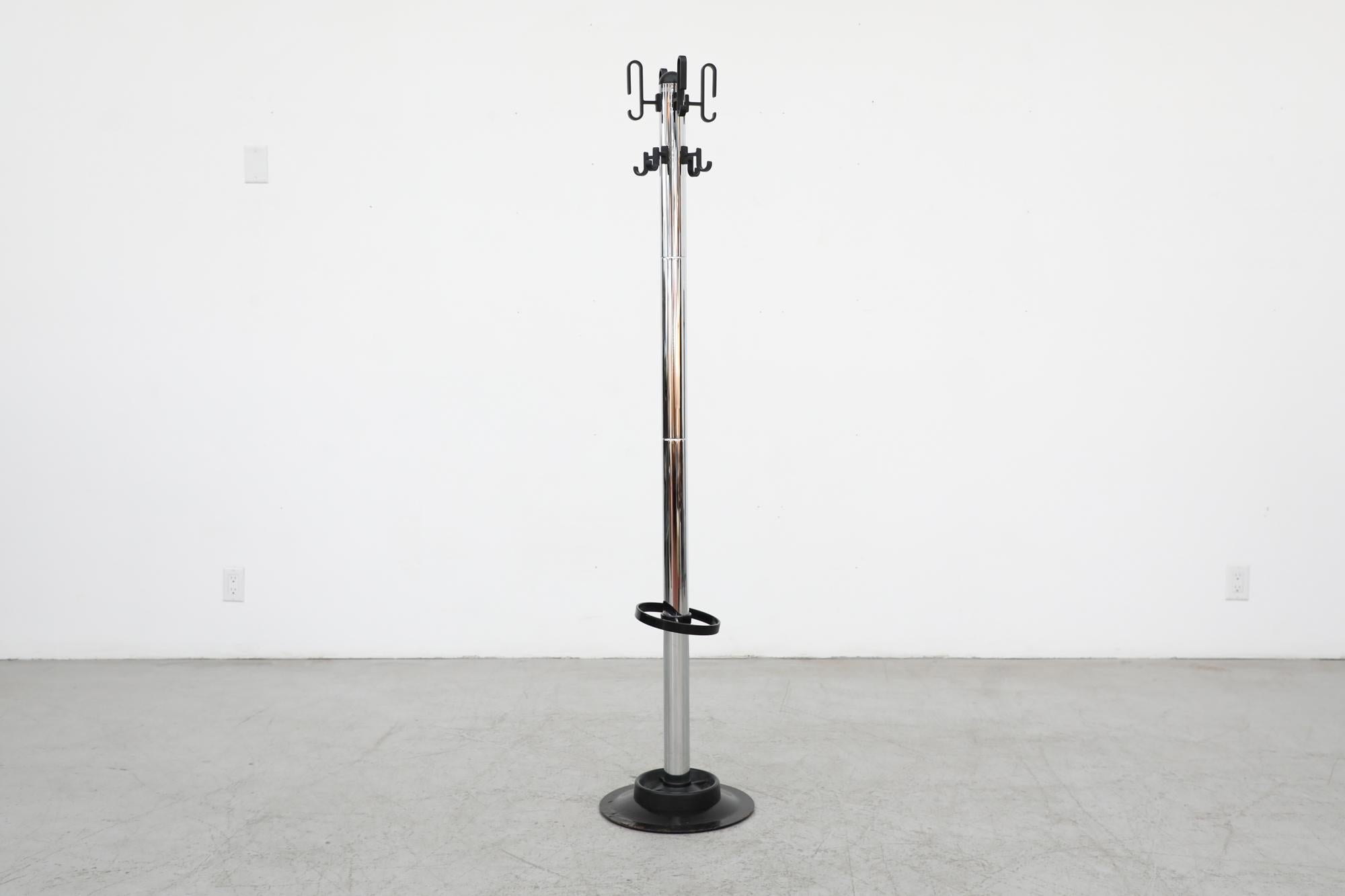 1970's Rosconi chrome standing coat rack with plastic hooks, plastic umbrella holder and metal base. In original condition with visible wear, including warping of umbrella holder and light scratches. Wear is consistent their age and use.