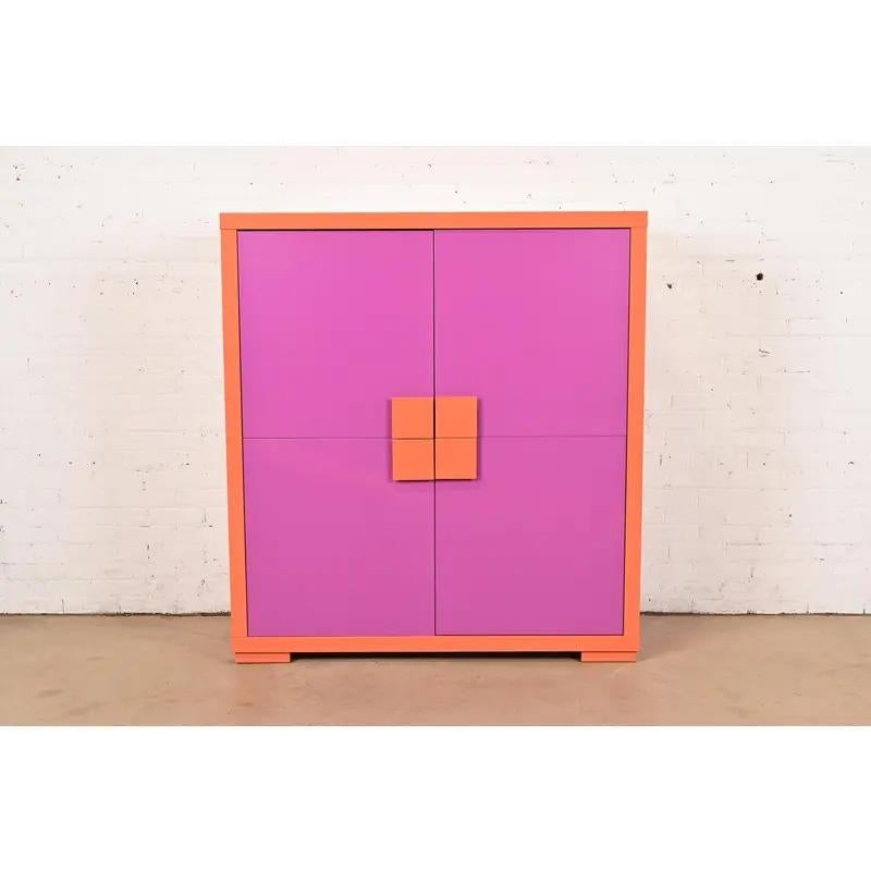 An exceptional Postmodern magenta and orange lacquered cabinet, bookcase, or bar cabinet

In the manner of Ettore Sottsass for Memphis Milano

USA, Circa 1980s

Measures: 51.25