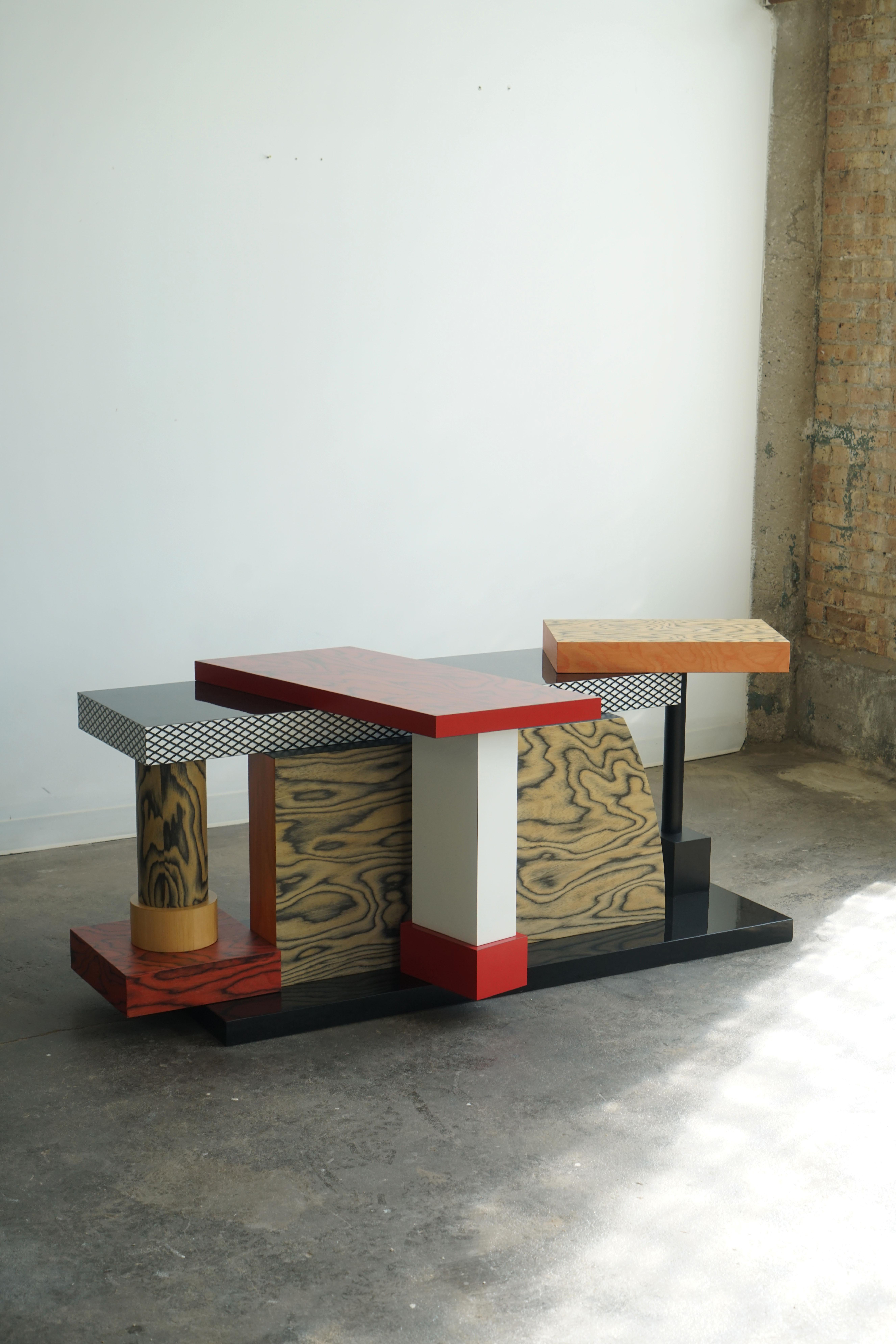 Tartar table designed by Ettore Sottsass, 1985.
Memphis Milano label.

The Tartar table encapsulates Ettore Sottsass’s distinctive style, his focus on geometric forms, and the patterns and colors he typically uses. Truly a standout, unique