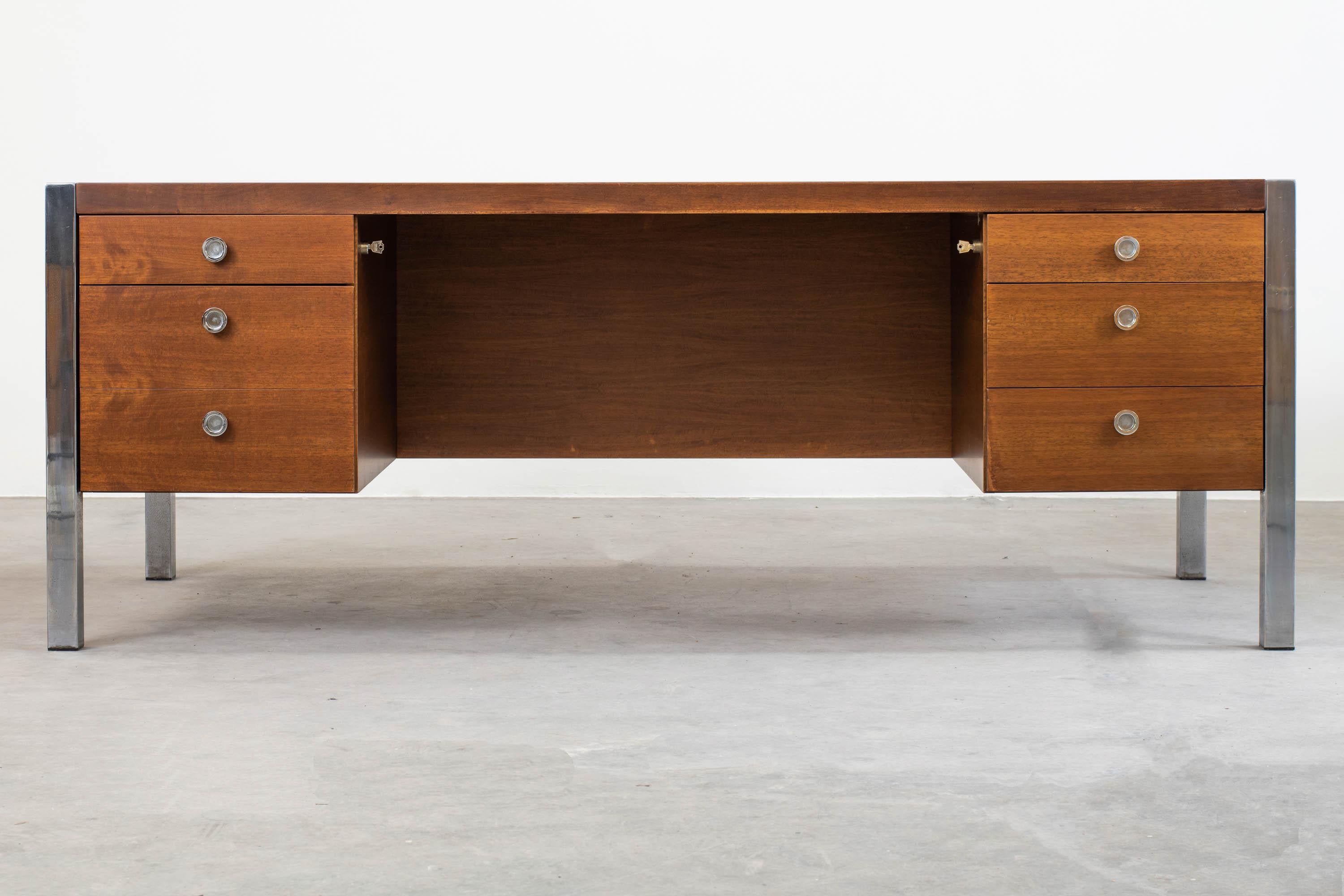 Tecnika desk with drawers, in veneered wood and chromed steel details (handles and frame). 
Designed by Ettore Sottsass and produced by Poltronova Production Design Center, Florence, 1970s.

Ettore Sottsass jr. was an Italian architect and