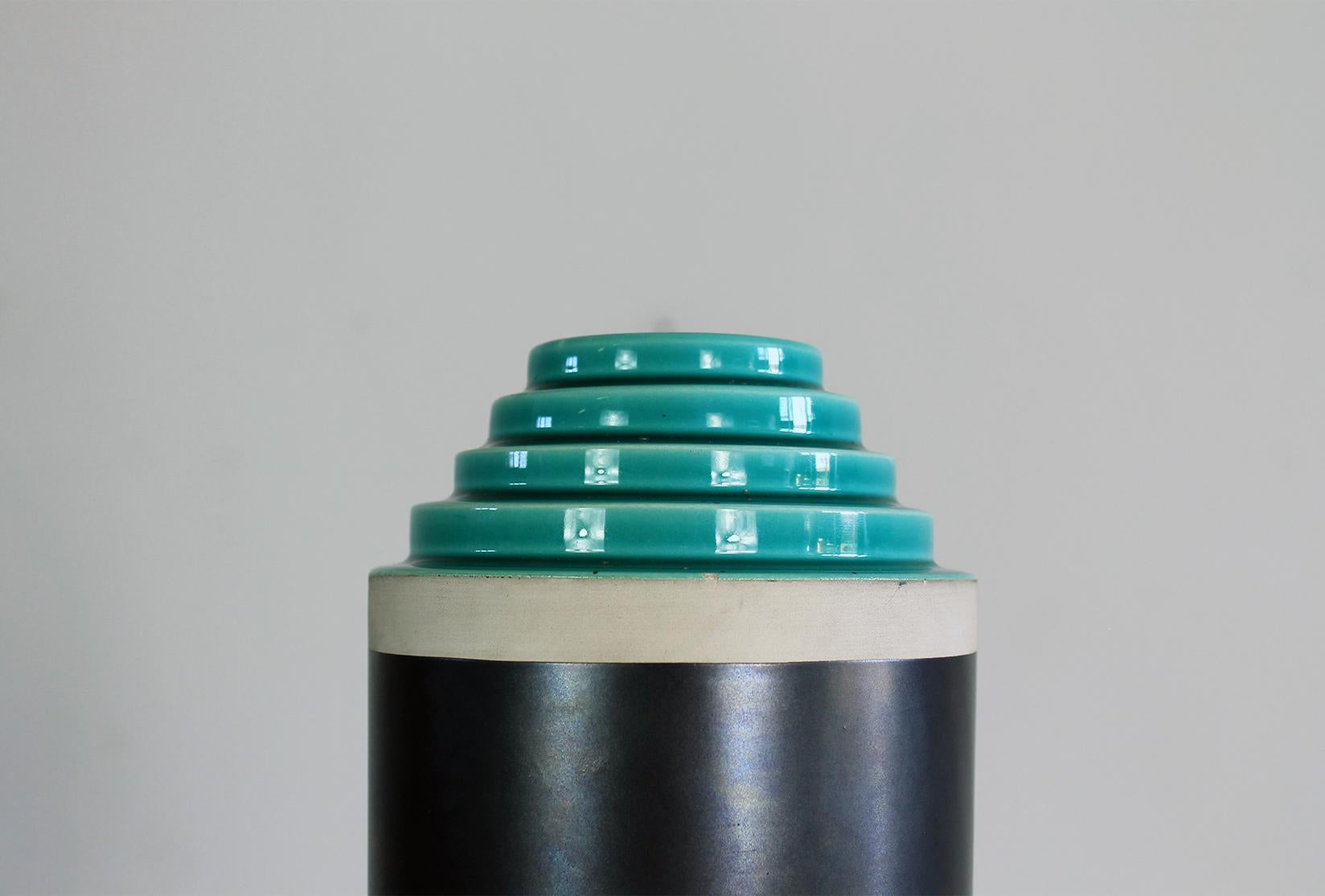 A vase from the stepped series in hand-turned in white clay enameled with two-tone matt gray and light green glaze, manufactured in the 1990s by Bitossi and designed by Ettore Sottsass Jr.

The stepped vases series was originally realized by Il