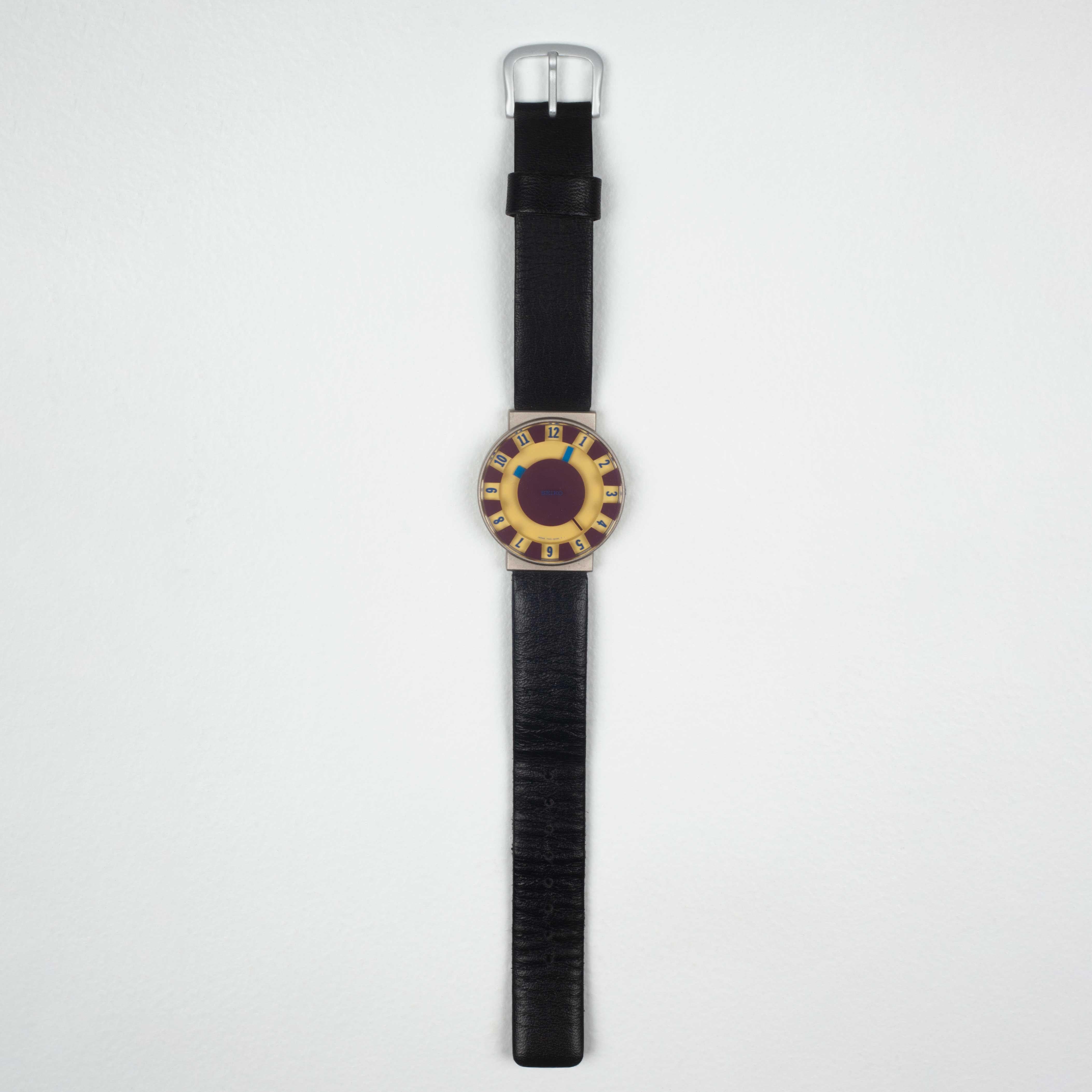 First edition, out-of-production SOTTSASS COLLECTION wrist watches designed by Ettore Sottsass, released in Japan by Seiko in 1992. Yellow and burgundy face and blue hands. A floating effect from colored elements appearing in layers of depth.