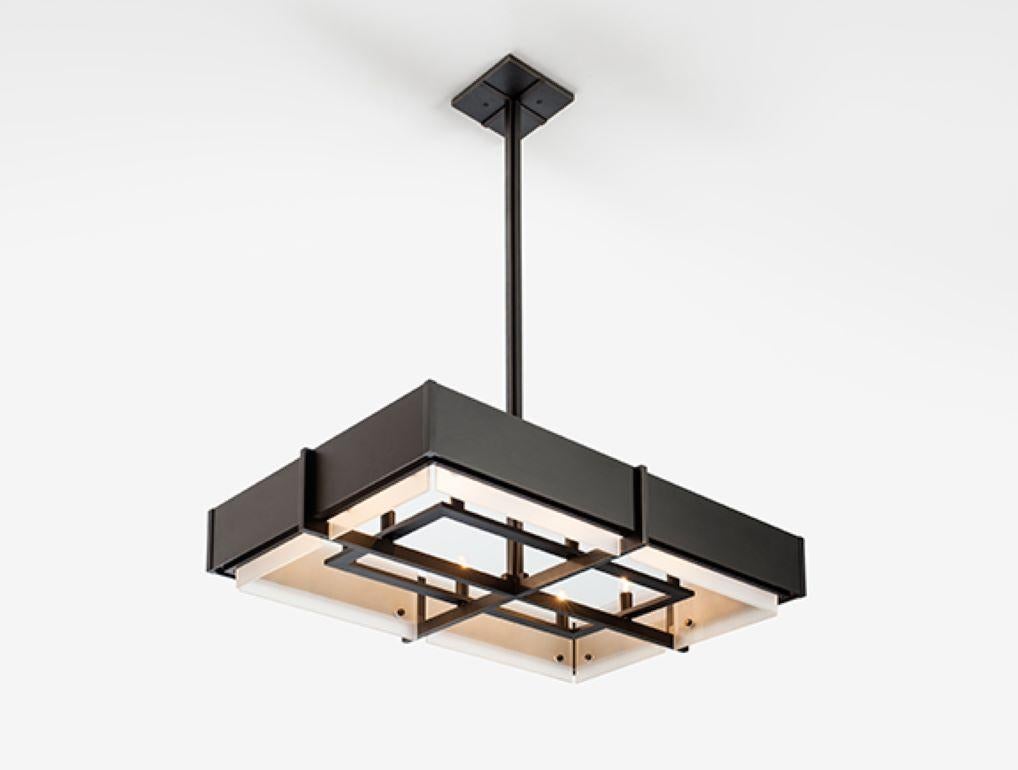 A HOLLY HUNT Studio classic, the Euclid chandelier is now available in rectangular geometry. Well-defined without being muscular, this incarnation of Euclid has presence over a dining table, and suits a clean, architectural environment. Made of
