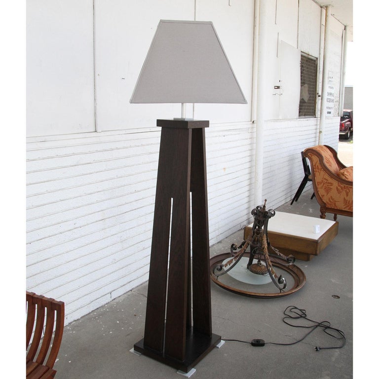 Euclid Mission Style floor lamp by Mirak Furniture by A. Soudavar
 
Oak wood floor lamp in a dark walnut stain with metal in brushed brass or aluminum. Sailcloth shade included. Wired and working.

DIMENSIONS:
70 3/4