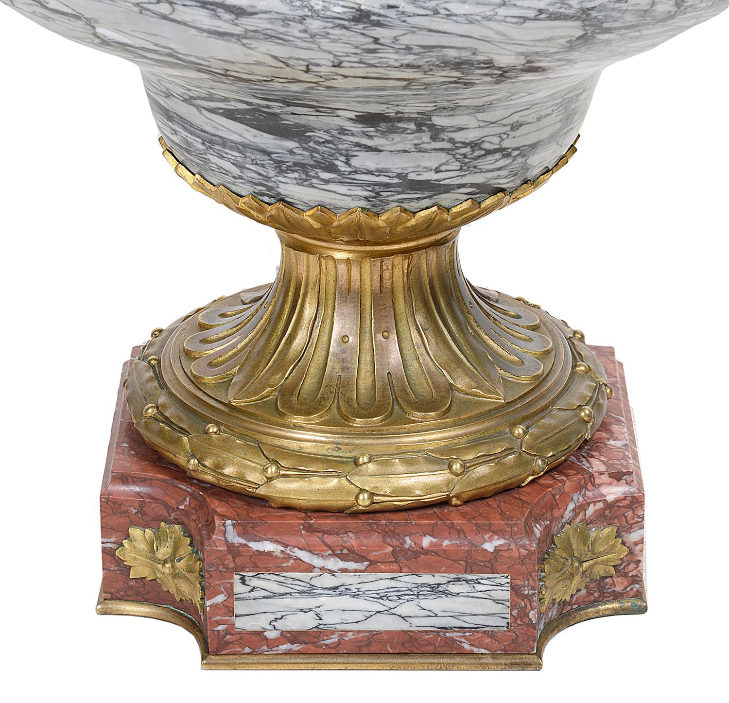 A very impressive 19th century veined grey marble lidded urn with wonderful gilded ormolu classical mounts of mythical dragon like handles and masks, raised on a fluted ormolu collar and rouge and grey marble plinth.
Signed E. Cornu (1827-1875).
