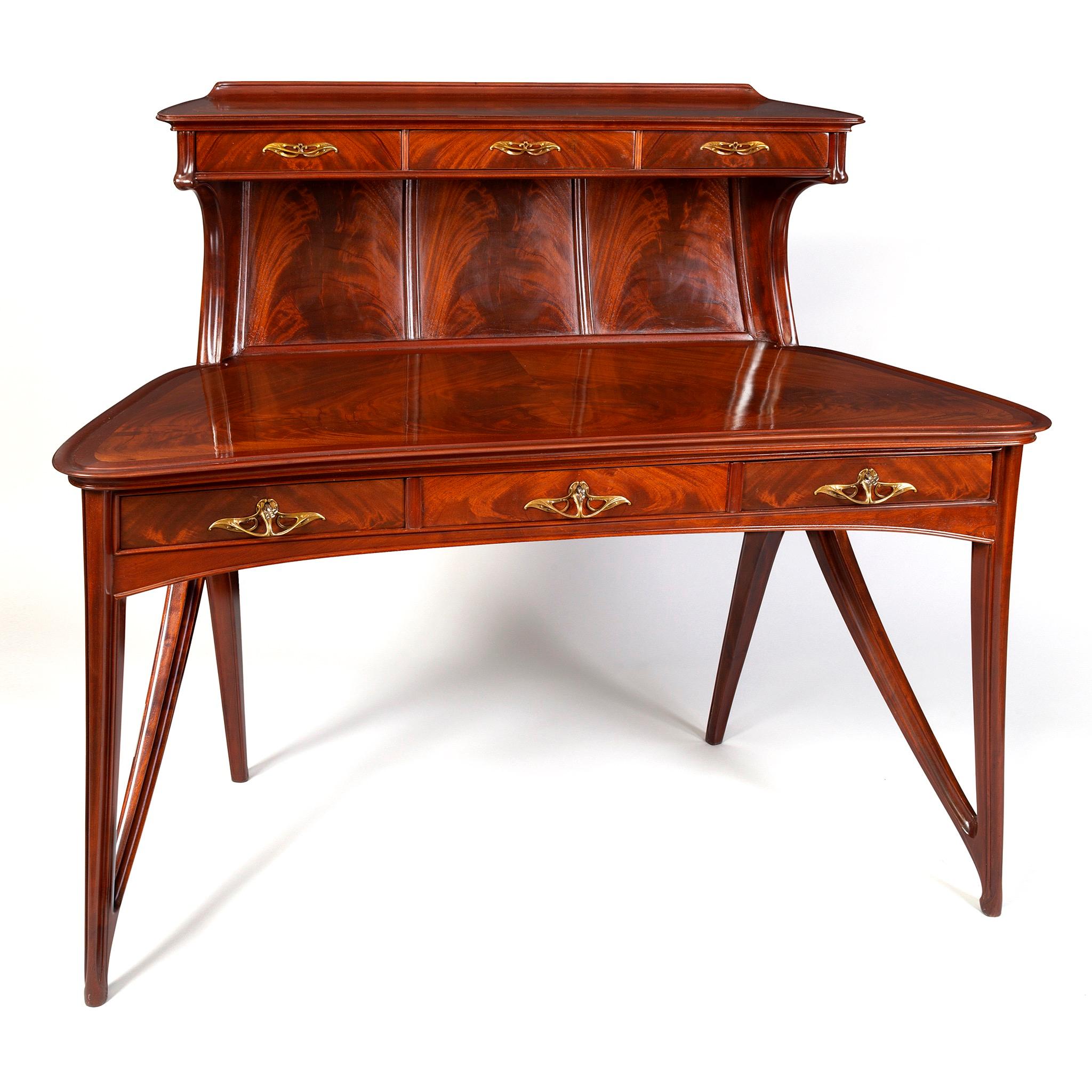 Described as “inspired by but never imitative” of nature, the work of Eugène Gaillard is celebrated for its marriage of strong lines and graceful composition. This elegant but robust mahogany wooden writing desk set provides us with a superb example