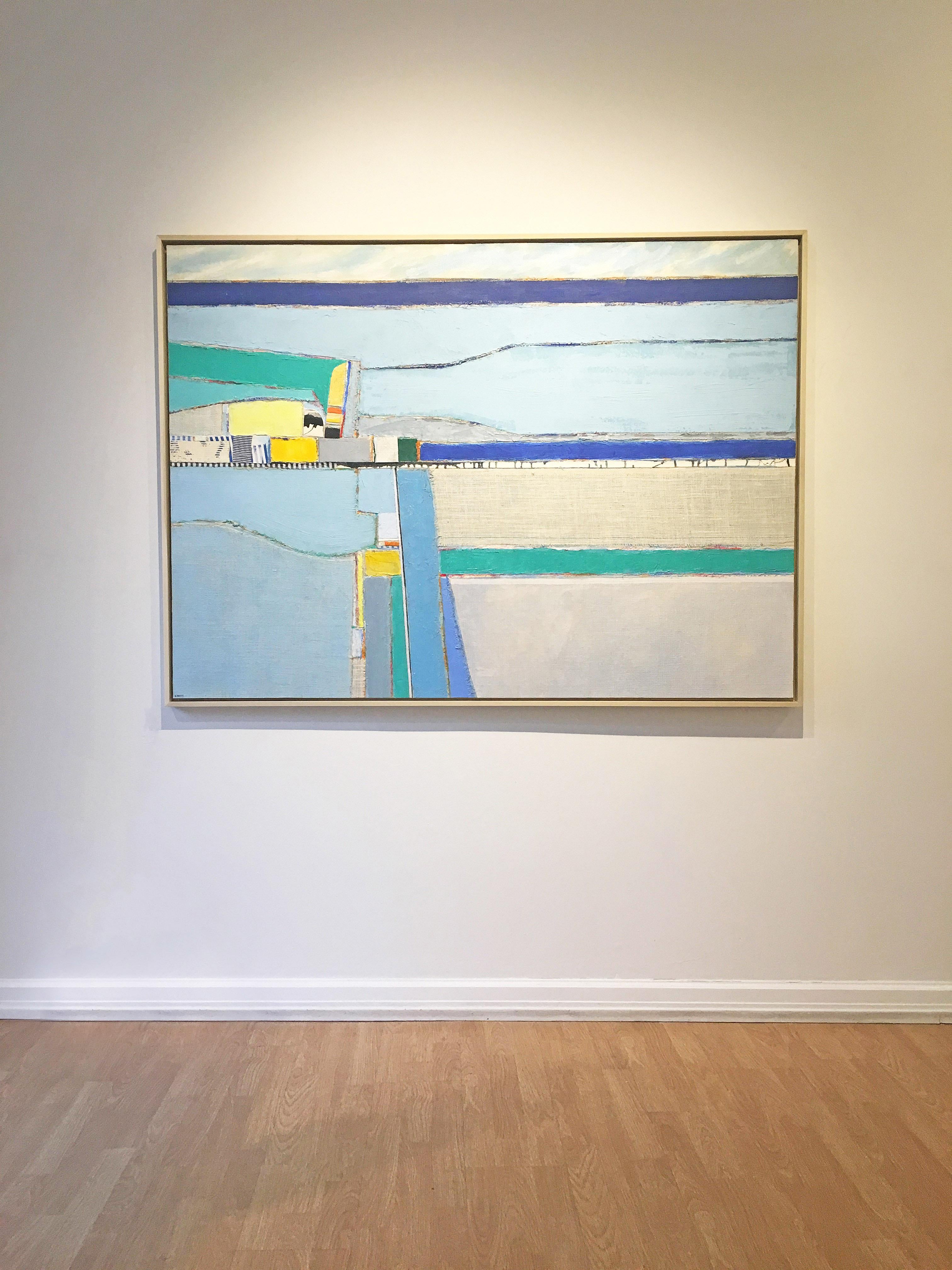 'Dubois Beach' by Eugene Healy, 2018. Oil and fabric collage on canvas, 46.25 x 63.75 in. / Frame: 48 x 65.75 in. This landscape painting features an abstracted coastal scene with land and sea in aerial view. In calming colors of dark blue, light