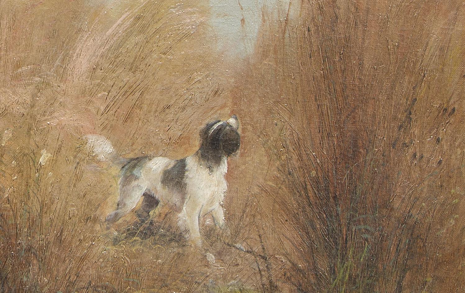 This fall scene shows the amber and brown wheat and grasses with a gray sky in the background.  It is a hunting scene with a hunter taking aim at a duck with a dog poised to retrieve it. This Impressionist painting by Eugene Petit is a horizontal