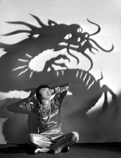 Anna Wong sitzend mit Drachen Schatten