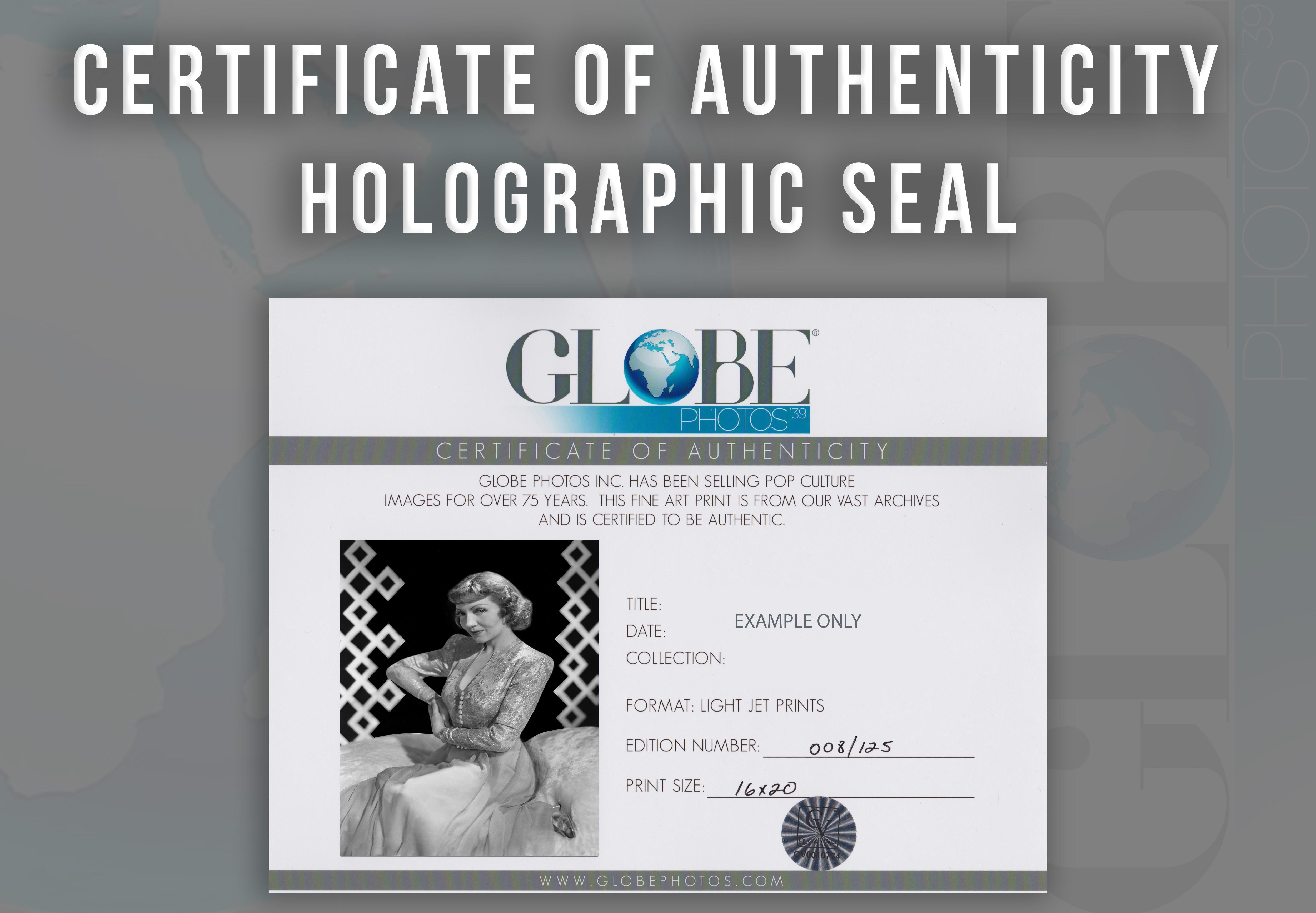 This black and white portrait features American film actress and a leading lady in Hollywood for over two decades, Claudette Colbert. Colbert is featured here looking to the camera for a glamour shot in a silky gown.

This image is credited to Globe