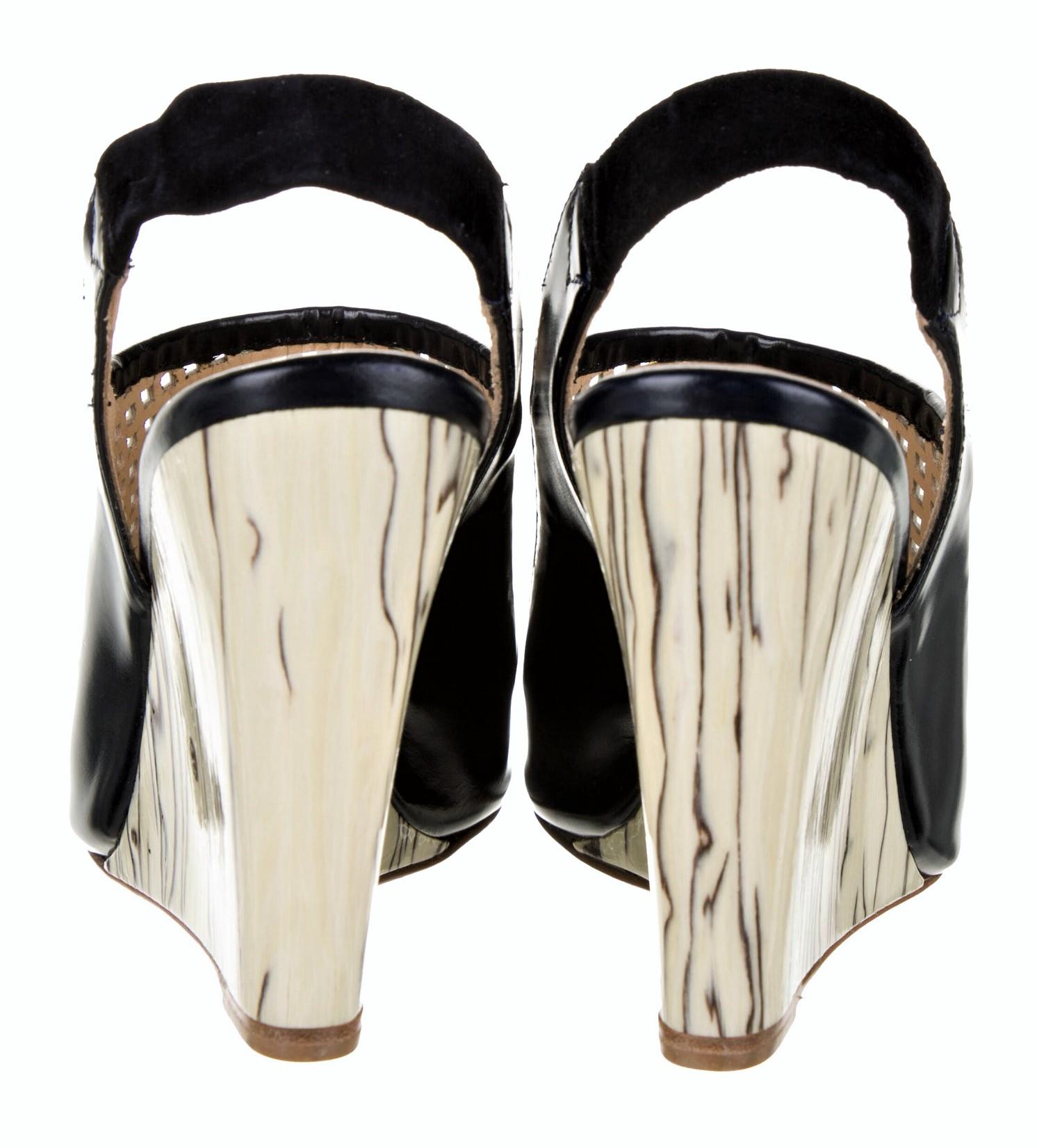 Eugenia Kim
$695
* Beautiful Dark Navy & Cream Leather Wedge
Perforated Leather Toe
Marbled Lacquered Heel
* Eugenia Kim did a limited collection of stunning shoes 
* Size: 39 (these run a half size small, so a U.S. 8.5)
* Wedge
Heels: 4.25