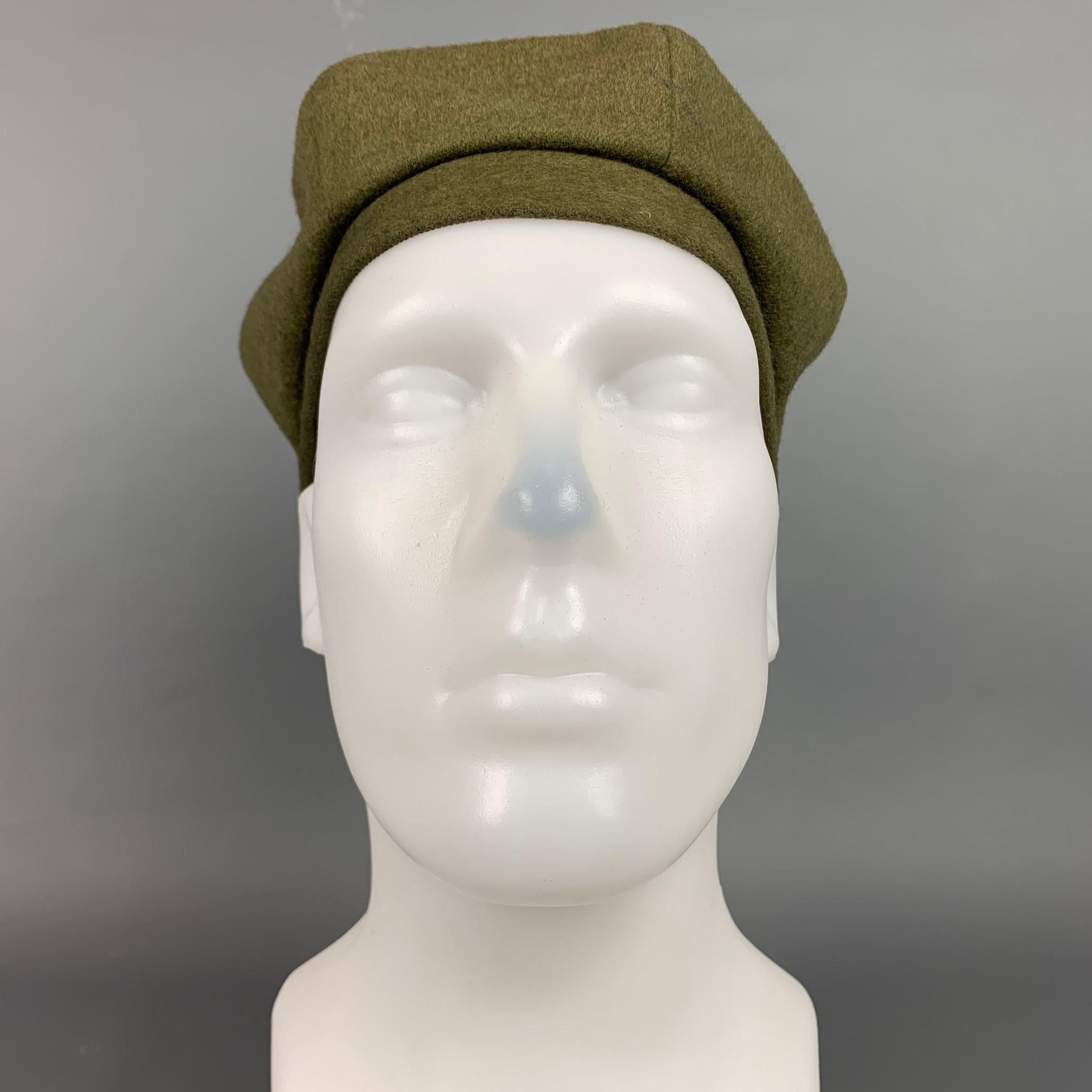 EUGENIA KIM hat comes in a olive material featuring a beret style.

Very Good Pre-Owned Condition.
Marked: Size tag removed.

Measurements:

Opening: 17 in.
Height: 5 in. 