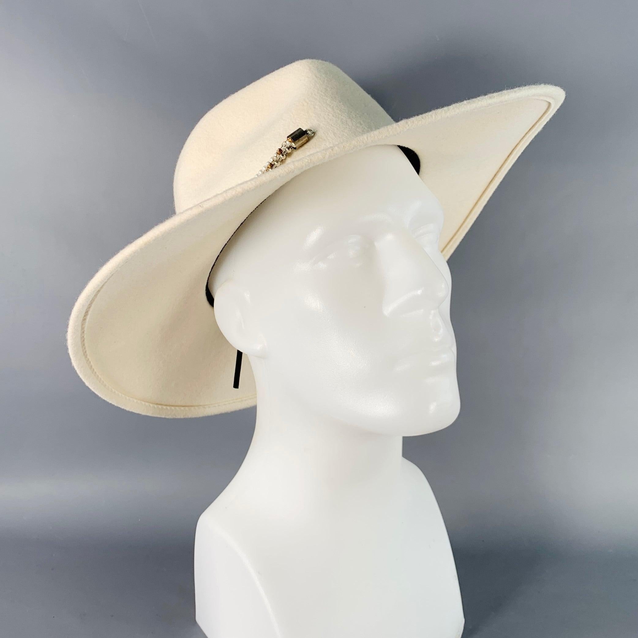 EUGENIA KIM fedora
in a white wool felt featuring a wide brim and chain link trim band detail.Excellent Pre-Owned Condition. 

Measurements: 
  Opening: 23 inches Brim: 4 inches Height: 4.75 inches 
  
  
 
Sui Generis Reference: 140073
Category: