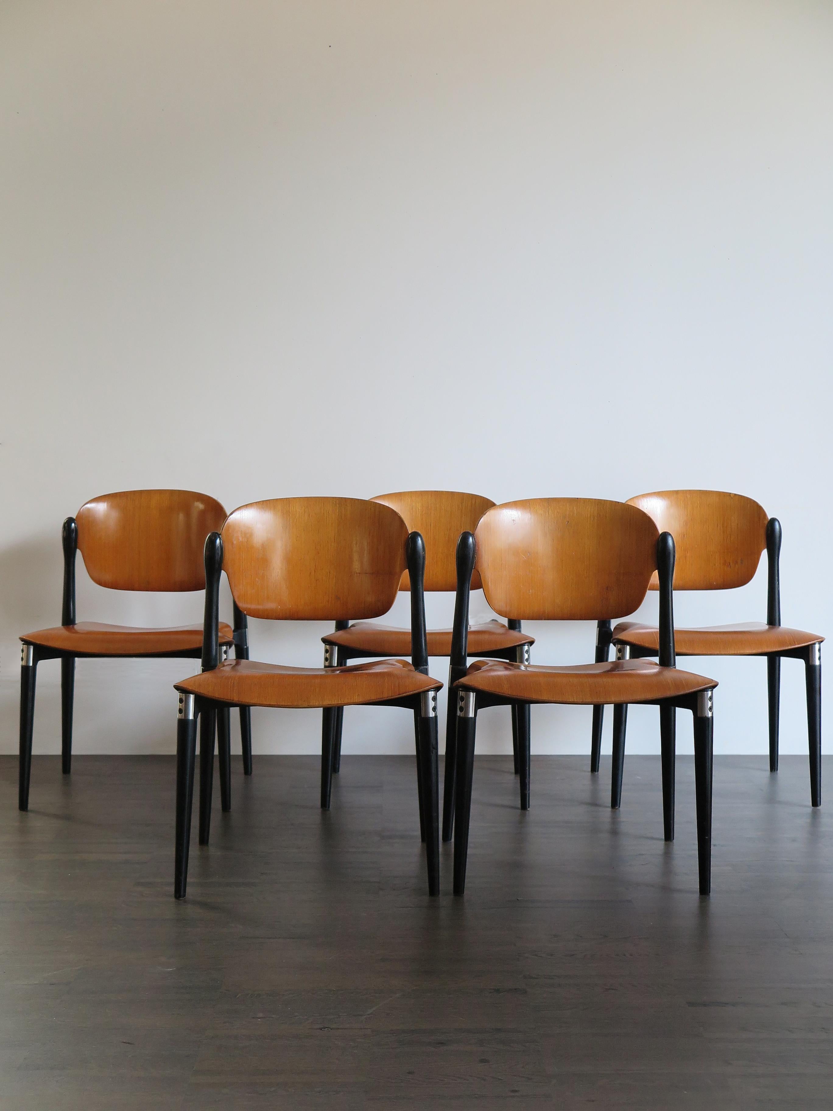 Set of five Italian dining chairs model “S832” designed by Eugenio Gerli (Milano 1923 - Milano 2013) and produced by Tecno Varedo from 1962, black painted metal frames, removable legs in black lacquered turned wood, seats and backs in curved wood,