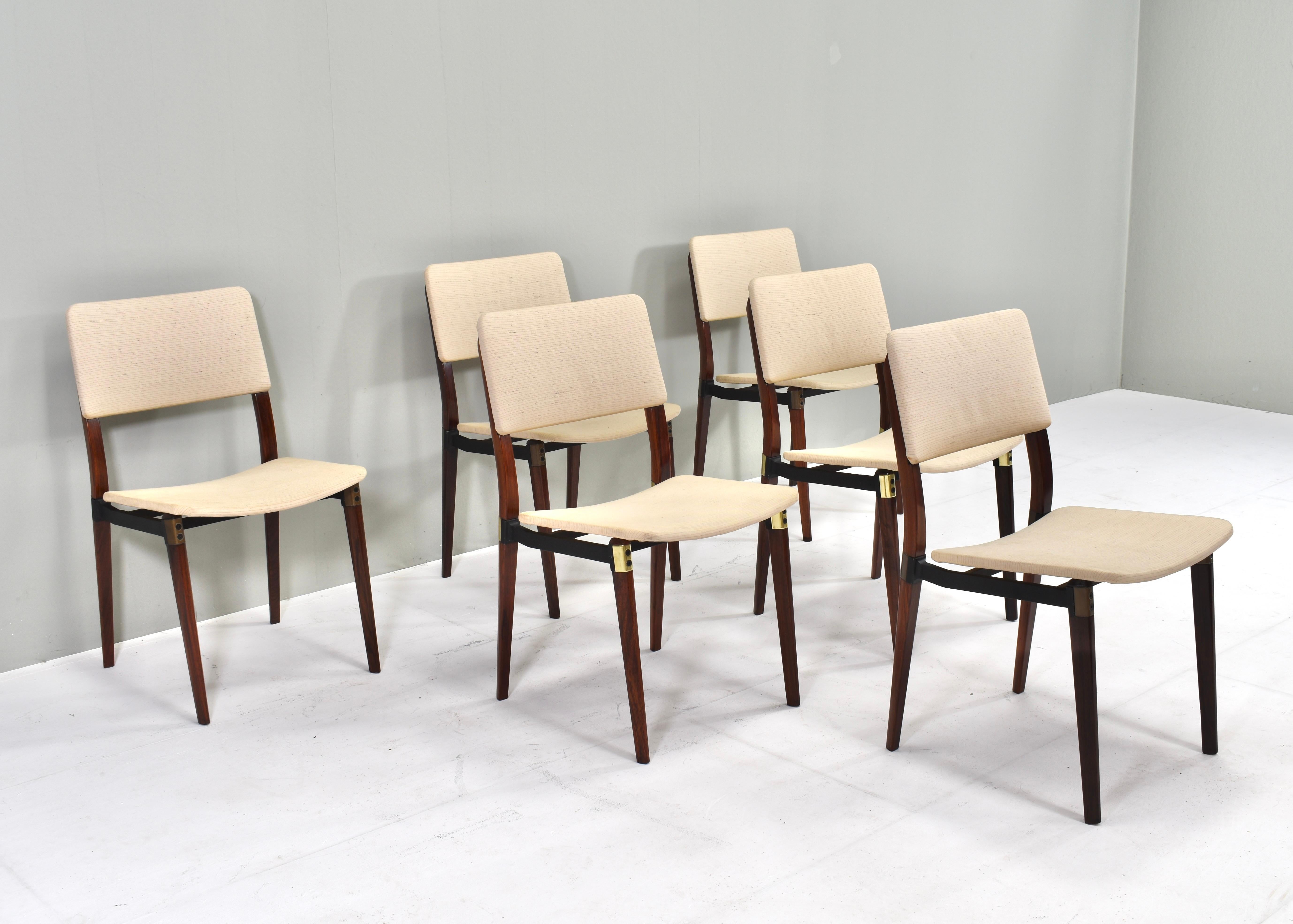Set of six S82 dining chairs by Eugenio Gerli (and Osvaldo Borsani) for Tecno, Italy – circa 1960. 
The chairs still have their original upholstery and remain in good condition with normal signs of age and use. Two chairs have brass details (rare)
