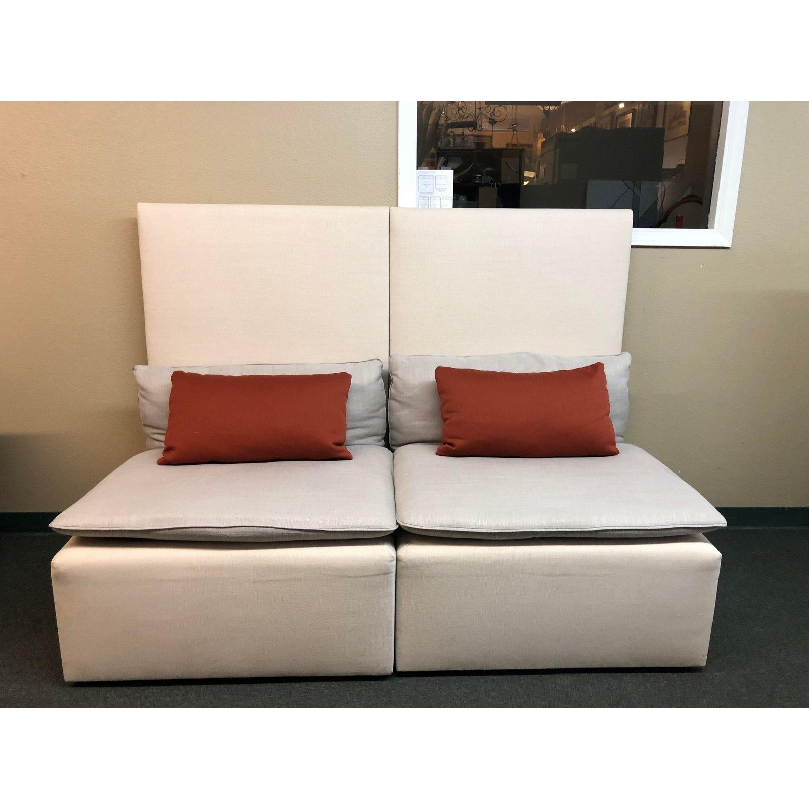 A modern modular sofa. Unique in its high back and monotone hues (ivory/gray), this five piece can be reconfigured in many ways to suit your space. Cushion filling sis 50/50 foam/down, the upholstery is a linen blend with contrasting orange decor