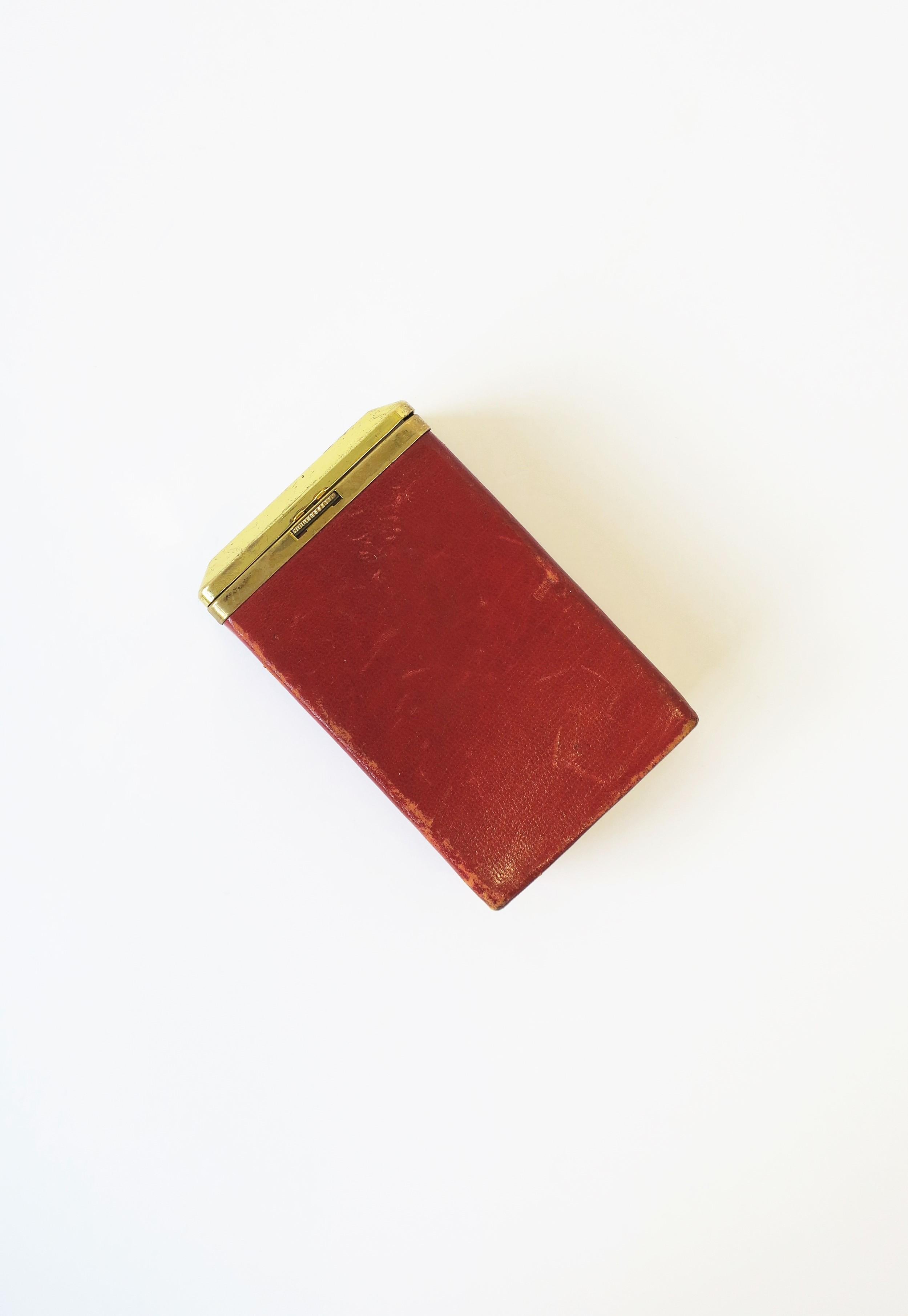 A chic Modern Euro red leather and brass cigarette 'box' holder case, circa 20th century, Spain. Box comfortably holds cigarette box, easily opens with the press of the serrated button, and closes equally as well. Piece is marked on bottom, 