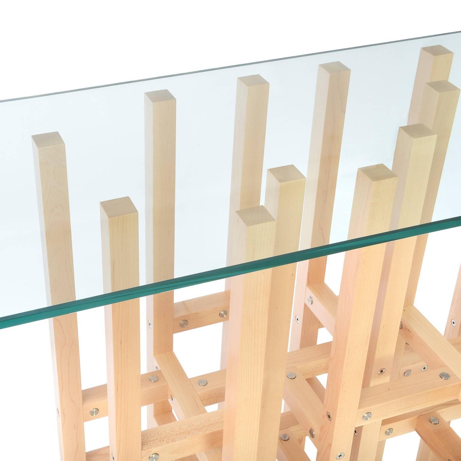 The Europa table by Peter Harrison is an intoxicating frenzy of elements which cross and overlap and resonate in the is modern console. 25 legs touch the floor and the glass. 45 horizontal elements create the structure. Levelers in each leg assure