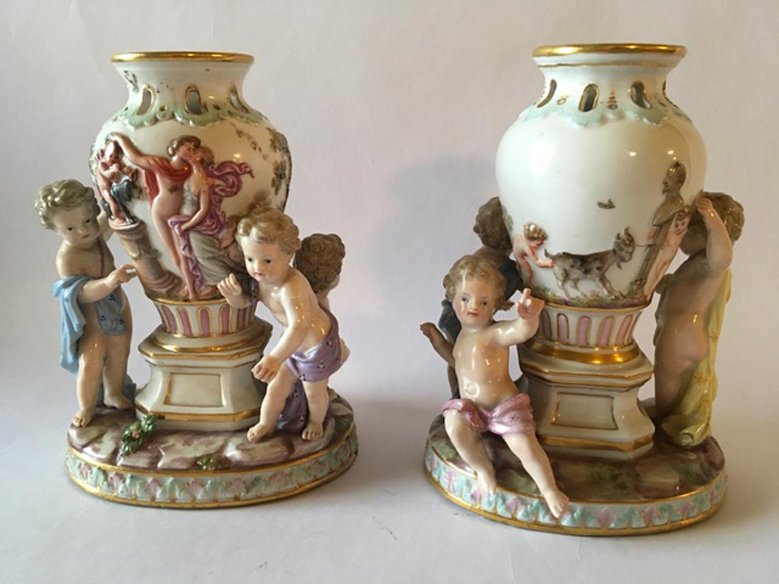 Elegant pair of Meissen vases on stand with child figures. The vases are decorated with mythological scenes on the surface.
Marked on the foot.
With certificate of authenticity.
Two arms restored.

 