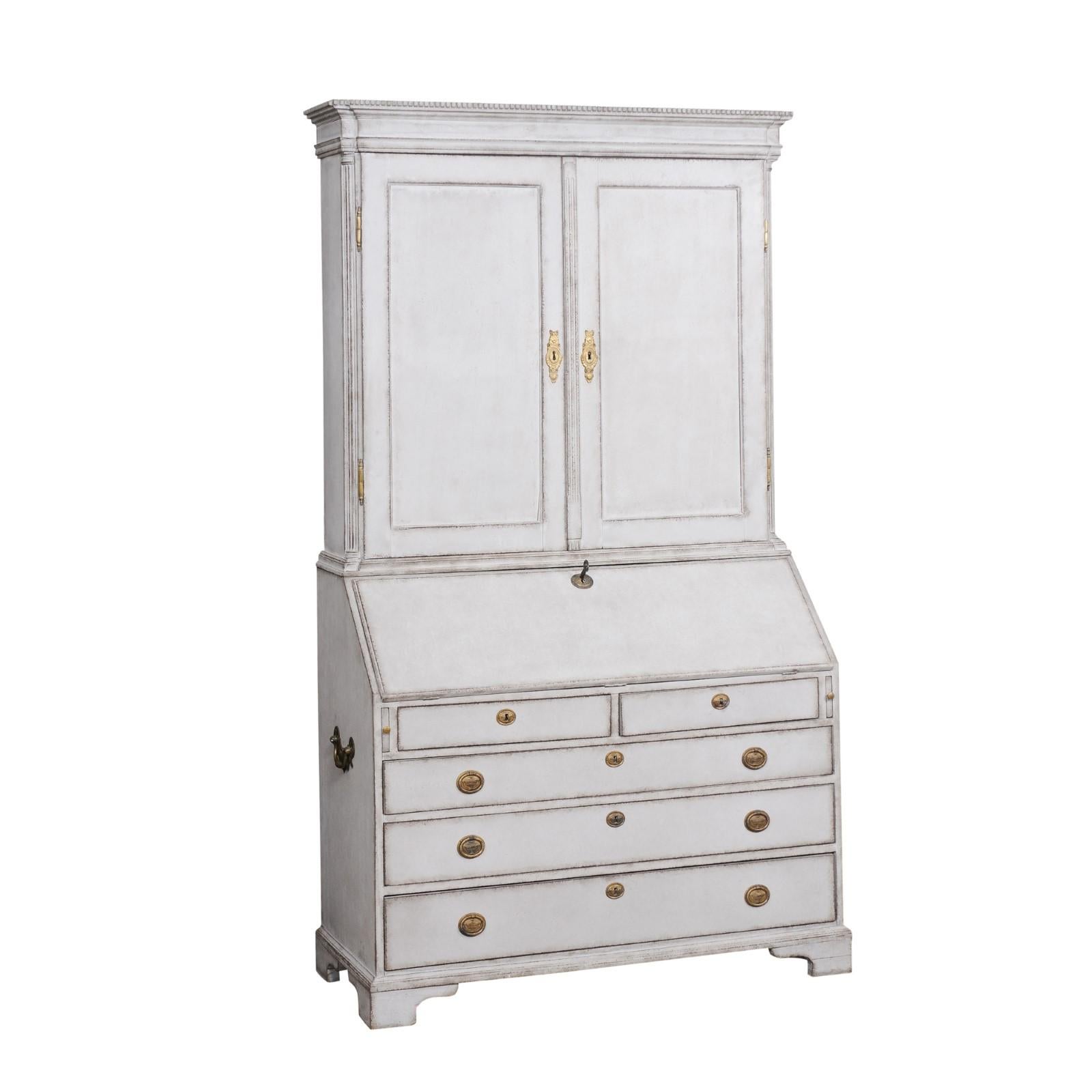 A tall European painted wood two-part secretary from the early 19th century, with molded cornice, dentil molding, slanted front desk and graduated drawers. Created in Europe during the early years of the 19th century, this tall painted wood