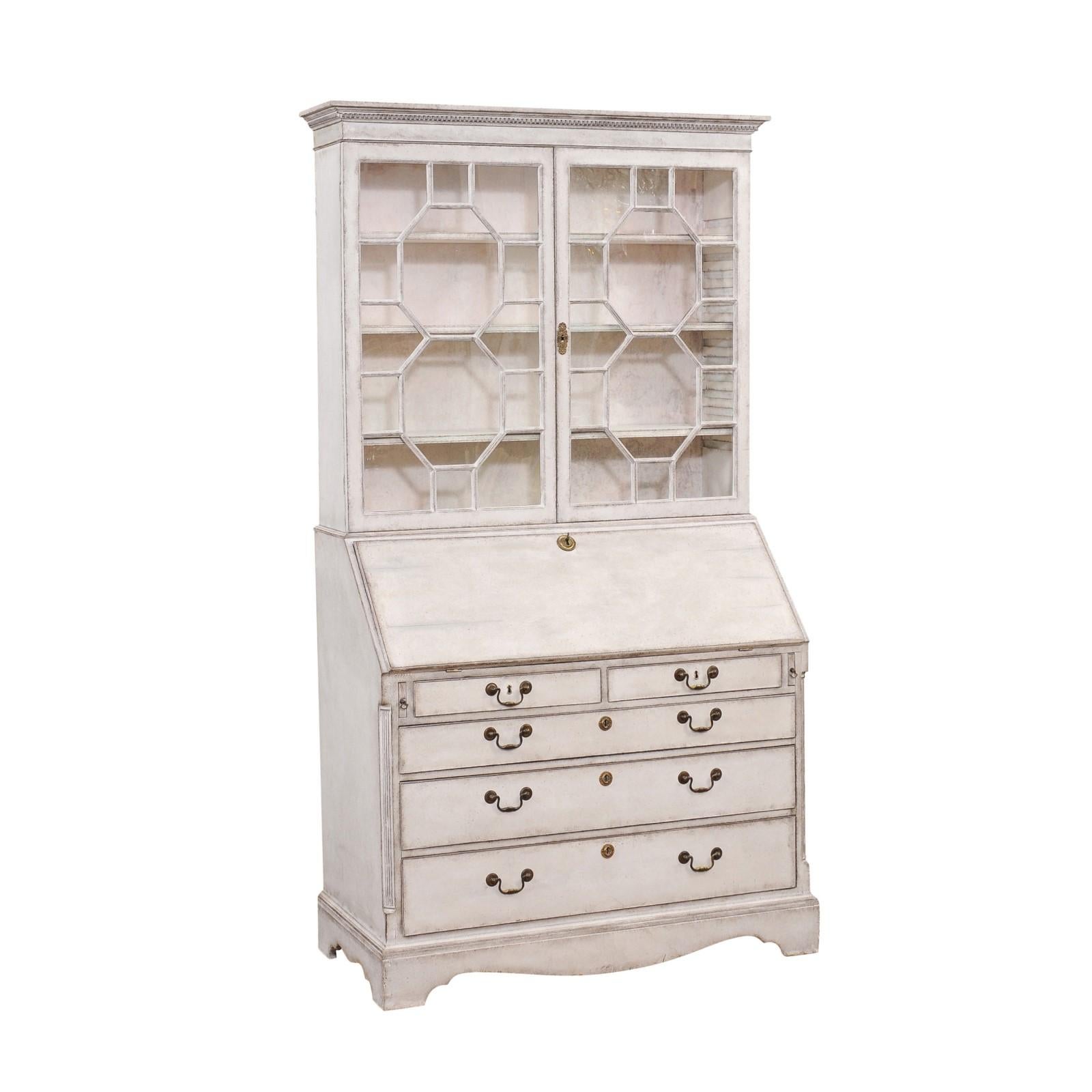 A European two-part tall secretary from the 18th century with gray / cream painted finish, old glass doors, slant front desk and five graduated drawers. Discover elegance and functionality intertwined in this stunning 18th-century European two-part