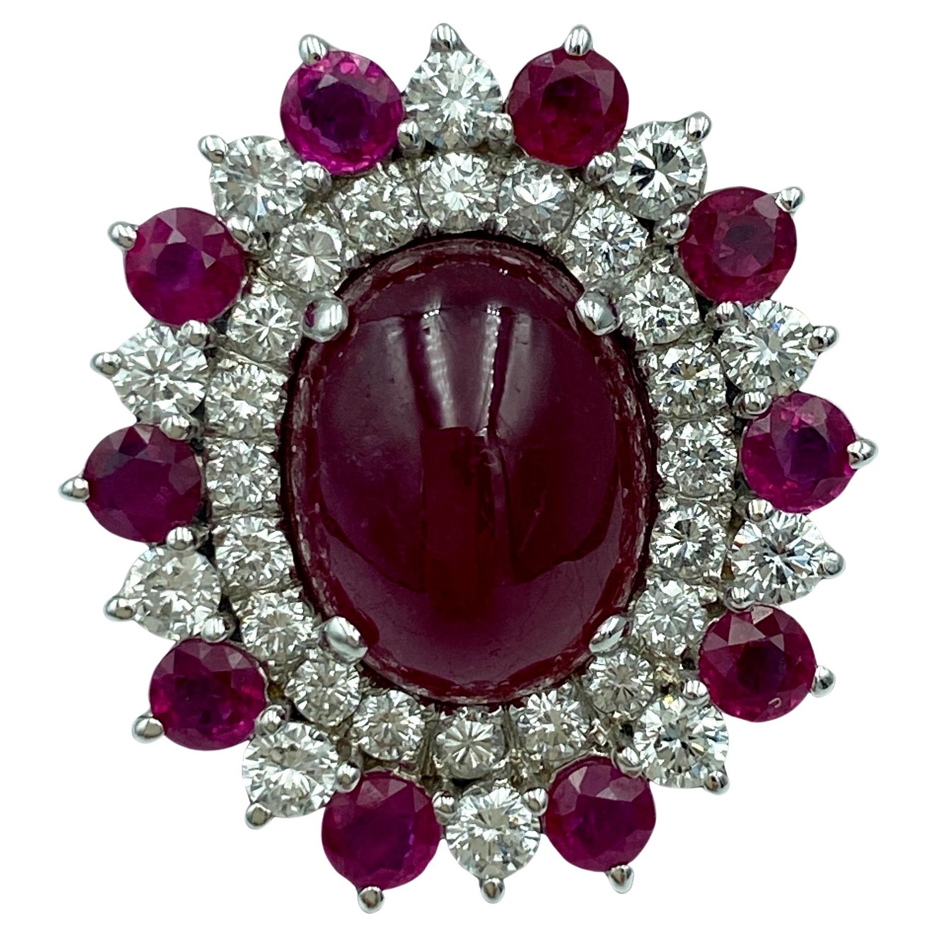 This outstanding natural cabochon ruby ring adorned with approximately 2 carats of VS quality F-G colour round cut diamonds is a stunning piece. The ring is part of a striking set with matching earrings, a photograph of which is given below. The