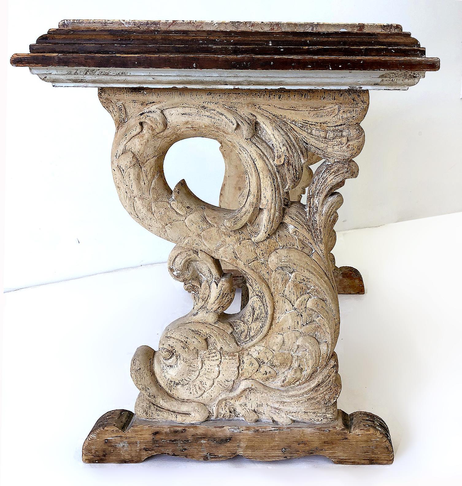 European antique carved dolphins table with marble top

Offered is an early 20th century antique wooden table with carved dolphins and a marble top. The table has a wonderful aged patina and lovely rustic antique feel. This is most likely a