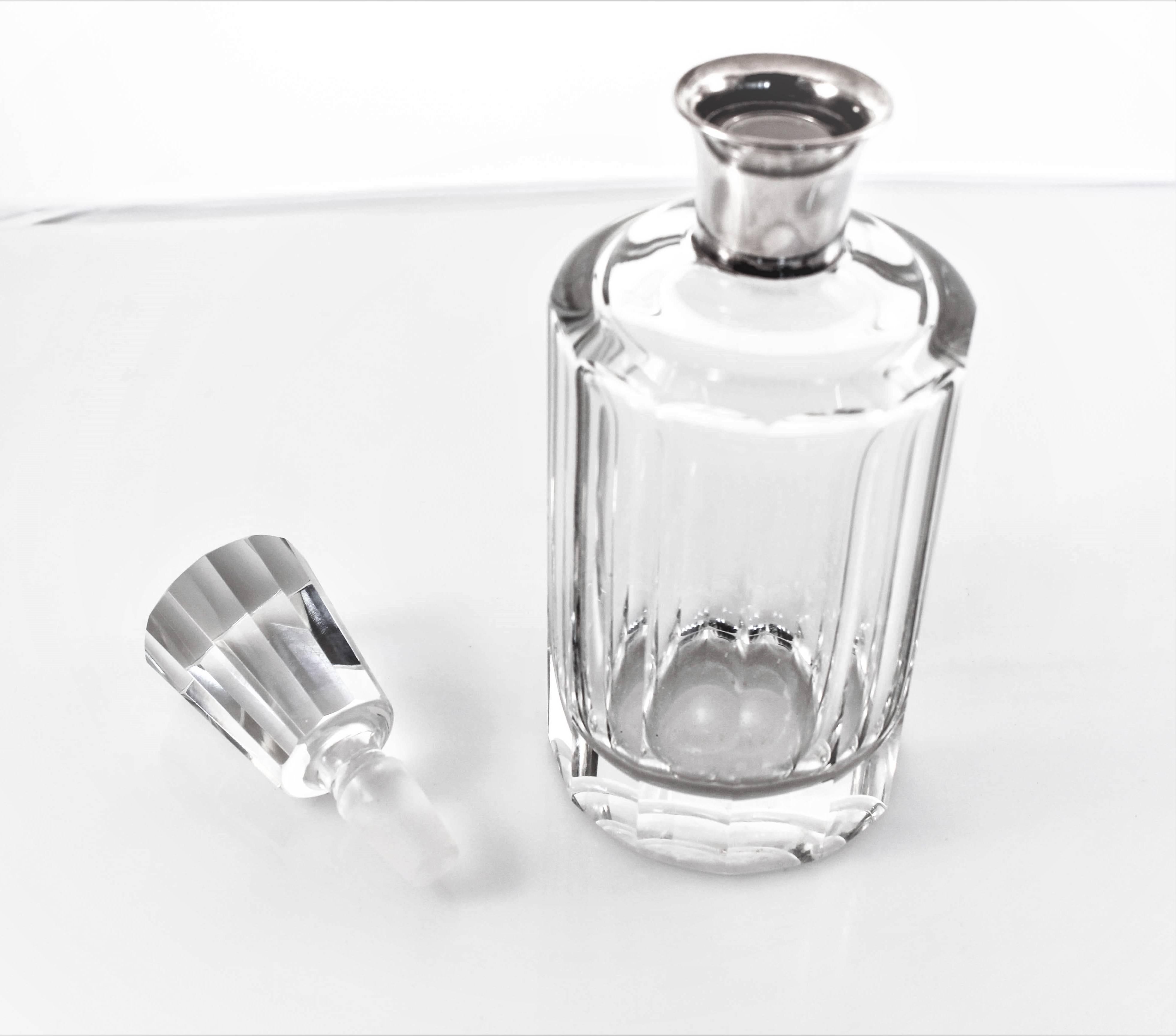 A lovely addition to your bar set, this vintage crystal decanter has a sterling neck. The bottle as well as the stopper are round in shape but have panelled design in keeping with the Art Deco period.
 