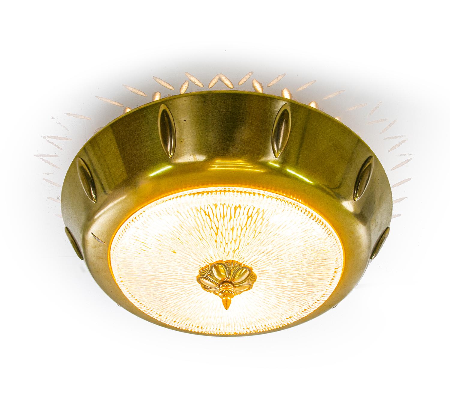 European Art Deco brass and textured glass flush light. 

Manufacturer: unknown. 
Execution: round. 
Style: art deco, mid century, modernist. 
Materials: glass and brass. 
Colors: clear and golden. 
Measures: width appr. 17.3