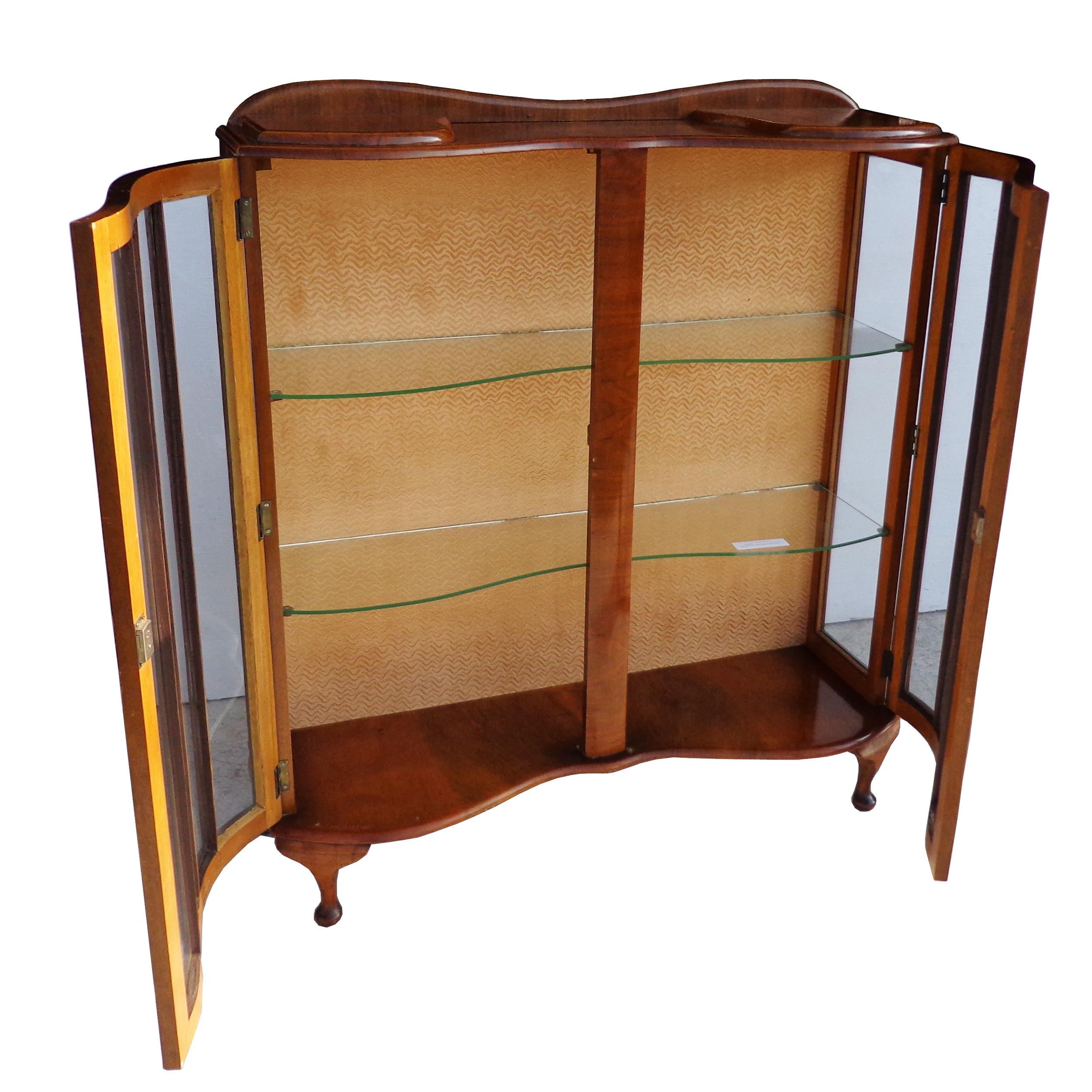 Art Deco walnut glass curio display cabinet

Beautiful concave front with glass display shelves. Queen Anne legs.

Measures: 41? Width x 13? Depth x 46.5? Height.


 