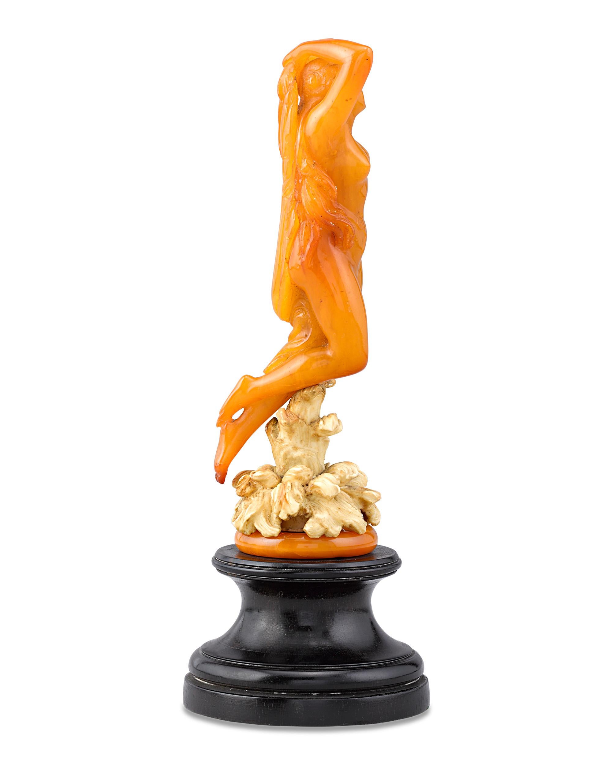 The enchanting water nymph in this exquisite Art Nouveau-era statuette is carved of solid amber. Art Nouveau, an avant-garde style that emerged in the early 1890s, received widespread popularity almost simultaneously throughout Europe and the United