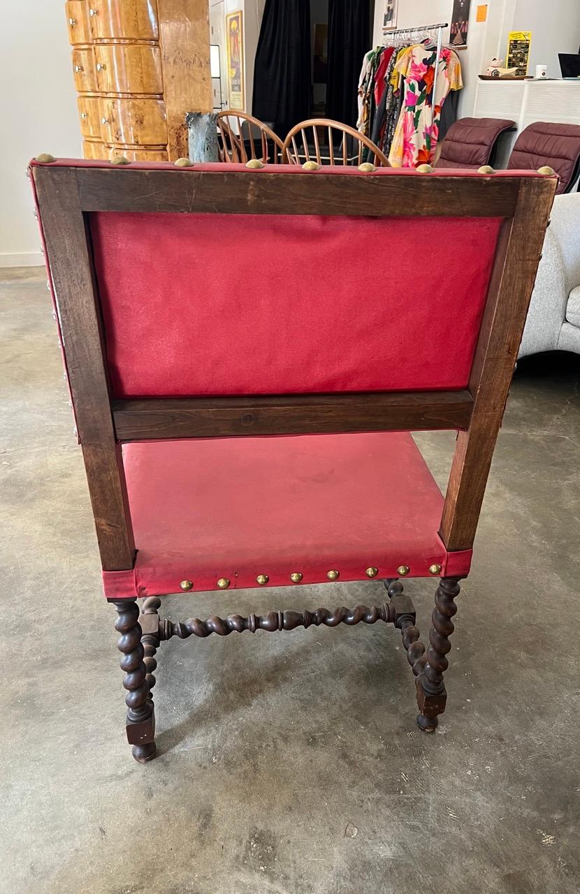 Large European barley twist chairs with hand-carved details and dark red vinyl upholstery.  Statement pieces that are sturdy and comfortable to sit in. 