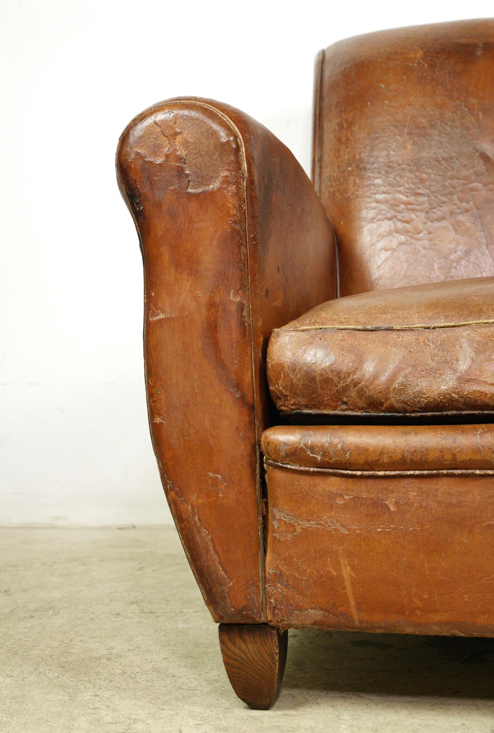 Brown leather club chair made in France. Good condition with surface wear from prior use. One available. Please note, this item is located in one of our NYC locations.