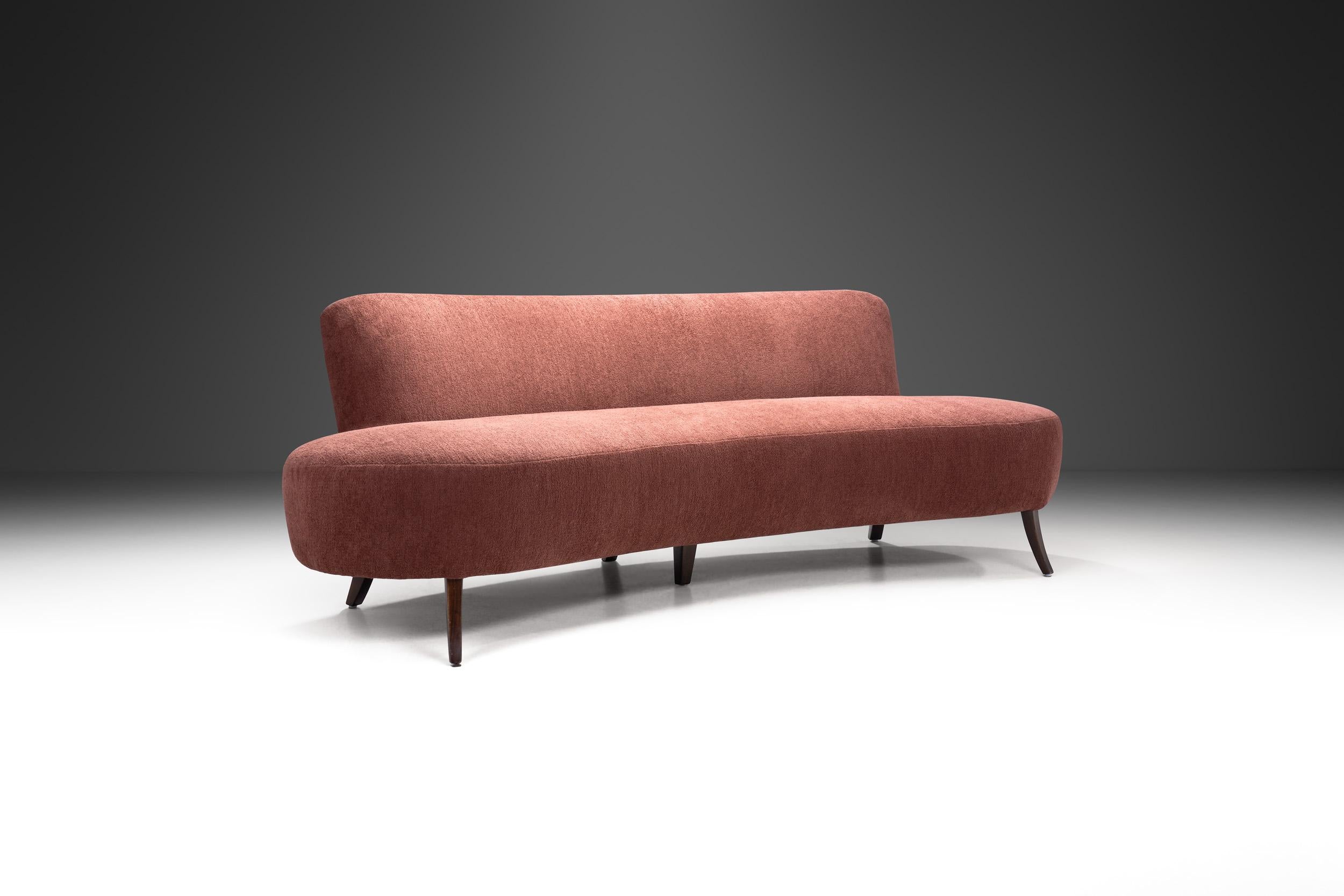 This beautiful curved sofa features the recognizable touch of European Modernism: exquisite materials, craftsmanship, and an elegantly curved shape, because of which this type of sofa is often referred to as the “kidney”, “banana” or “boomerang”