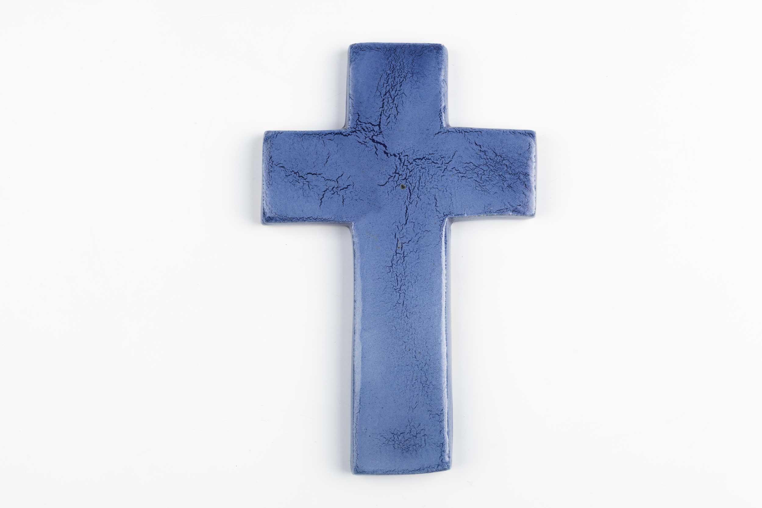 Wall crucifix indigo blue-violet color with semi-gloss crackle glaze. This piece is part of a large collection of unique ceramic crosses, all made in Belgium between the 1950s and late 1980s. From modernism to brutalism, they range from being as