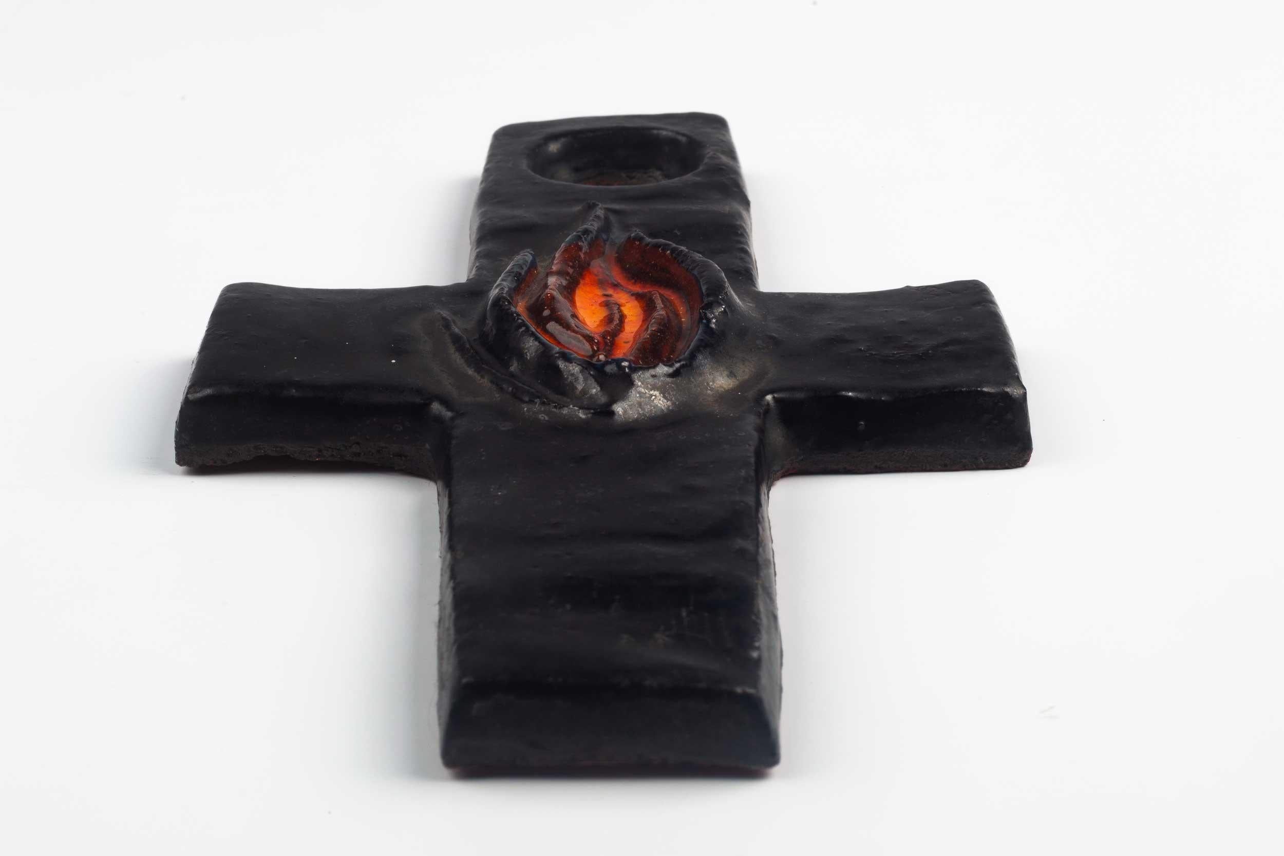 Belgian wall cross in glazed, hand painted ceramic with central decorative volume in the shape of a flame. 

From modernism to brutalism, the crosses in our collection range from being as futurist as a modernist church to as raw as a Brutalist