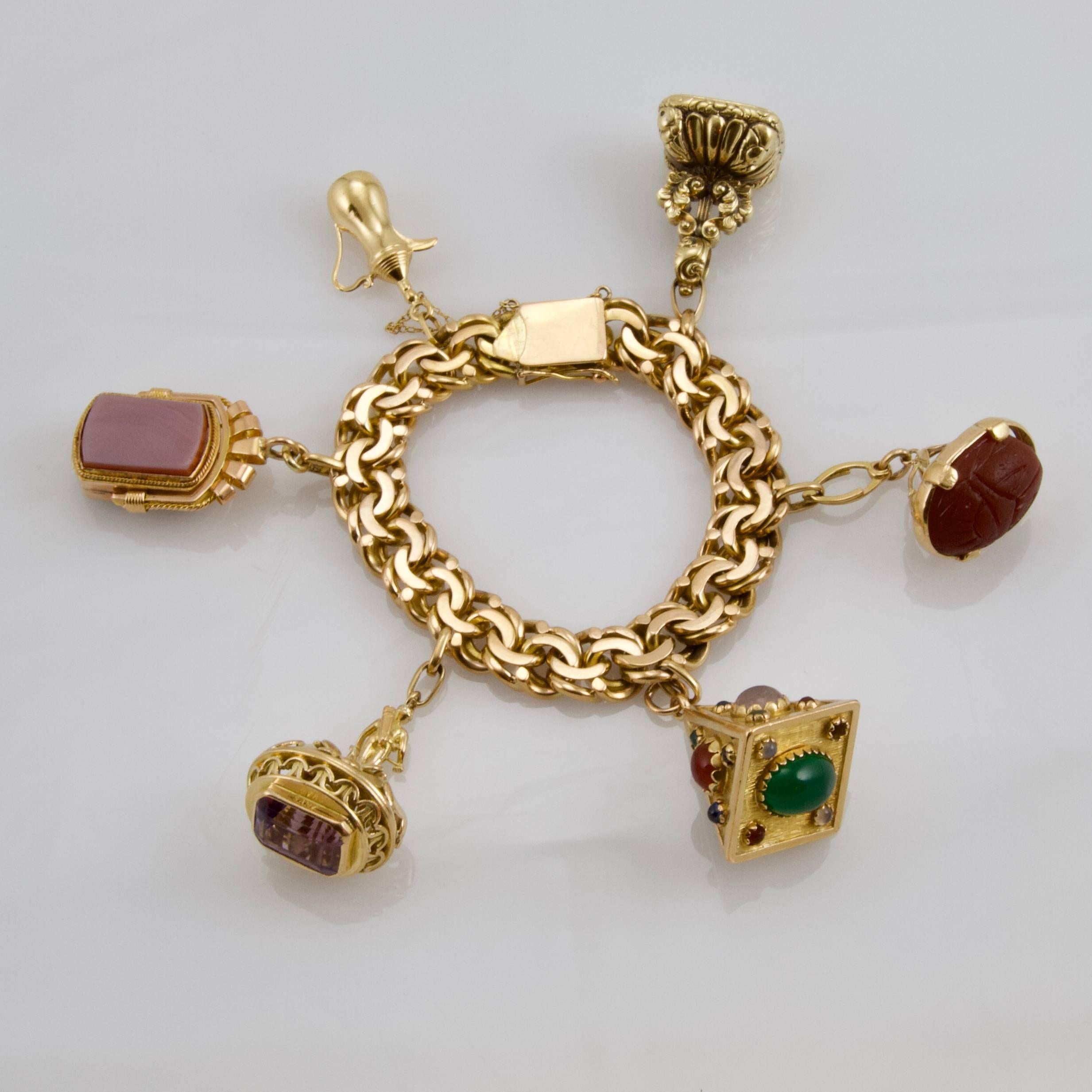 Very chic yellow gold large chain bracelet enhanced by gold and hardstones charms. Two seals from XIX century, four from XX century. One set with a paste imitating amethyst. 
Made in Europa ( Italia or England) around 1950.
French recense mark.
Two