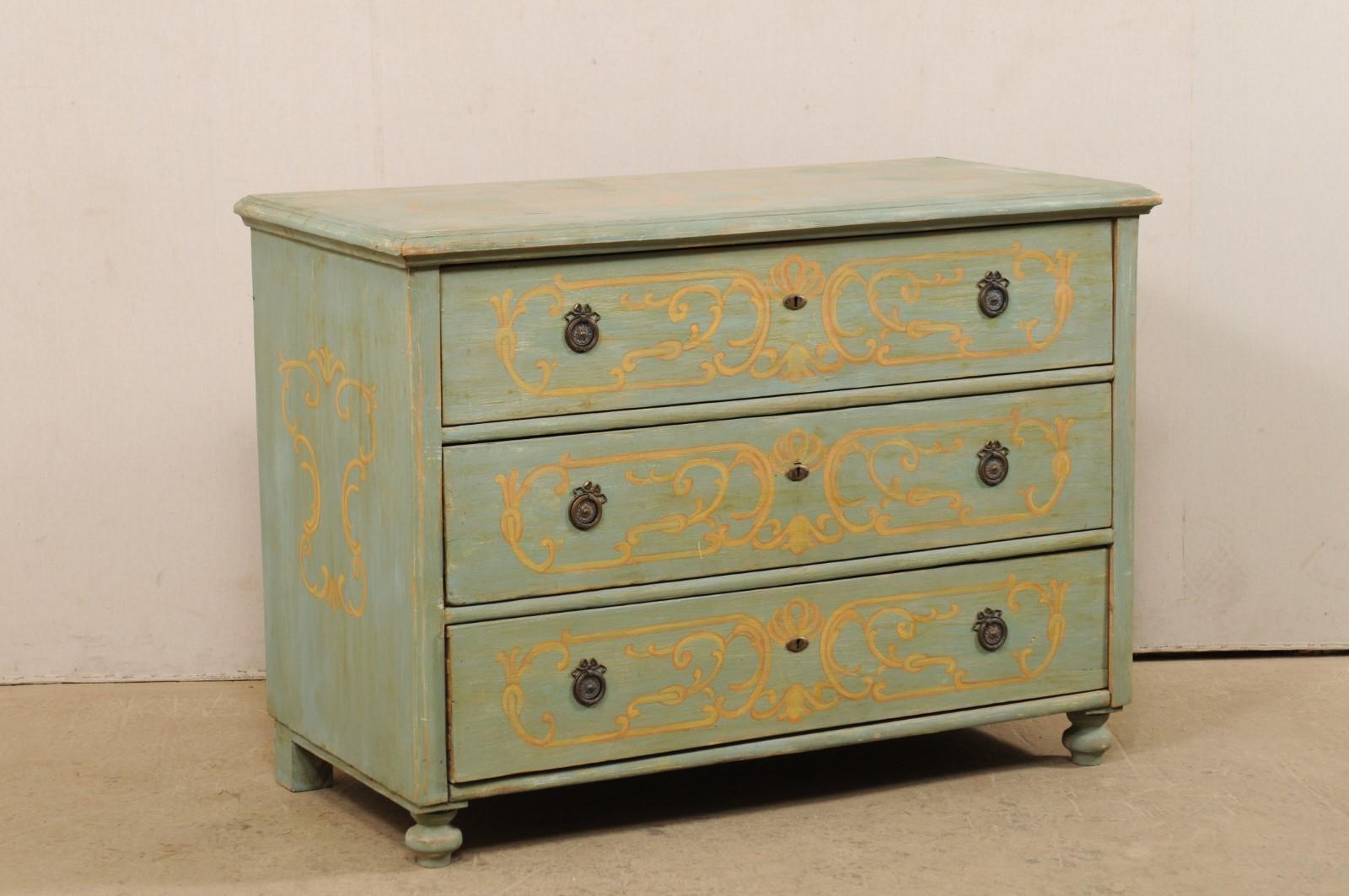 A European hand painted wood chest from the turn of the century, (late 19th-early 20th century). This antique chest from Europe features a rectangular-shaped top with beveled edges, atop a case housing three dovetailed-drawers, and raised upon