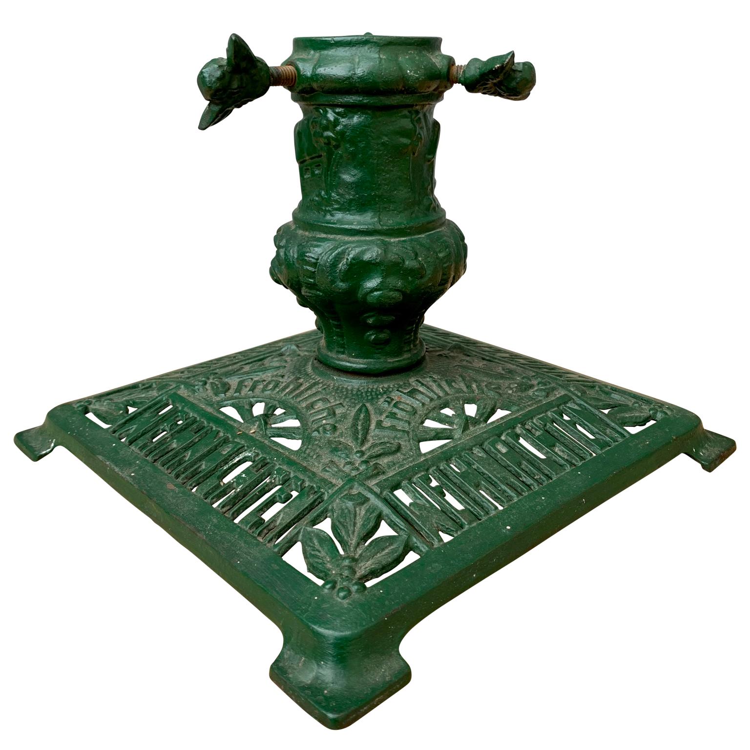 A German-Austrian green painted Christmas tree stand in cast iron from the early 1900s. 
Decorated with mistletoe leaves and 