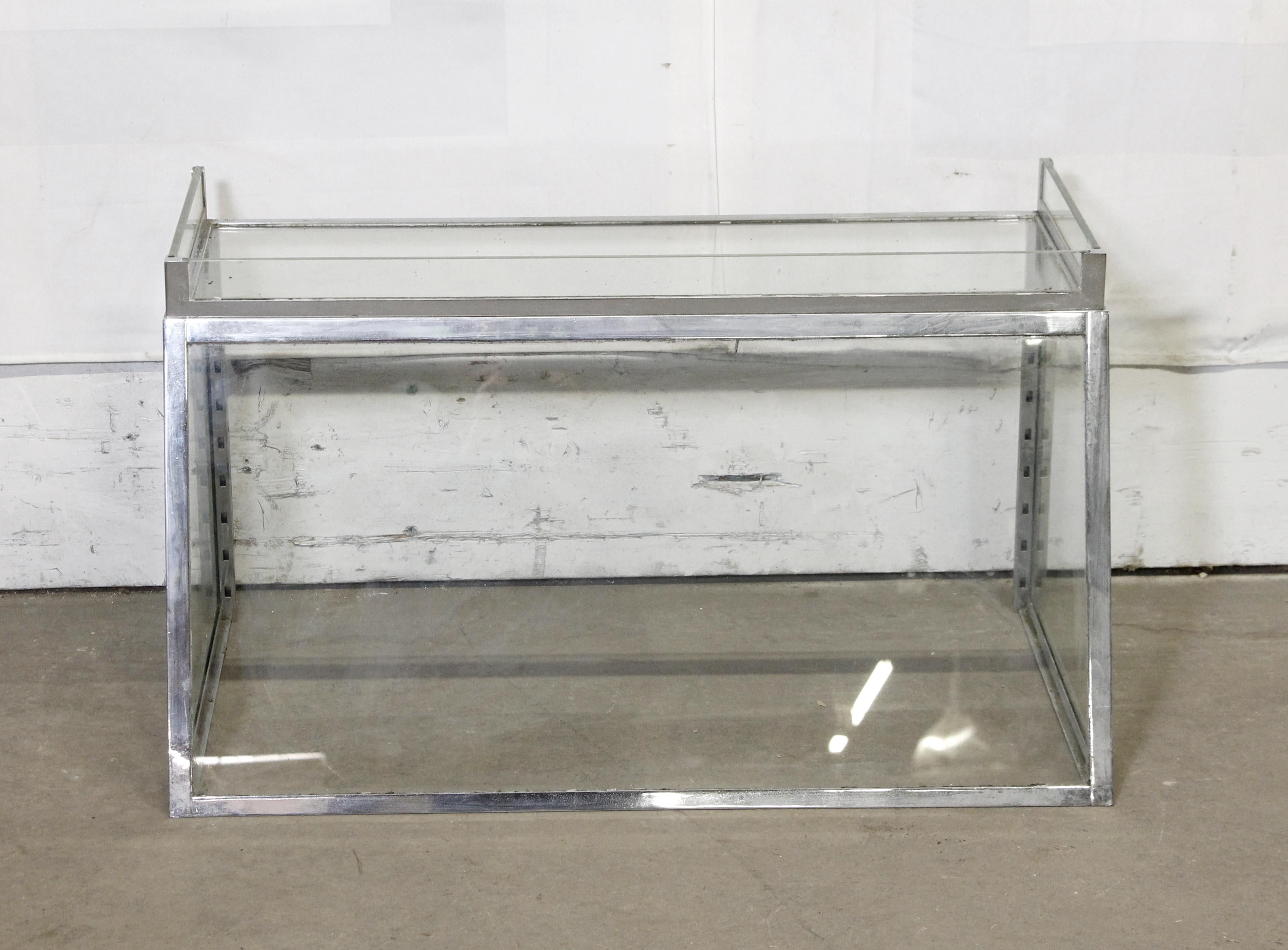 20th Century European Industrial store trapeze style chrome plated brass vitrine. Features clear glass sides with glass 