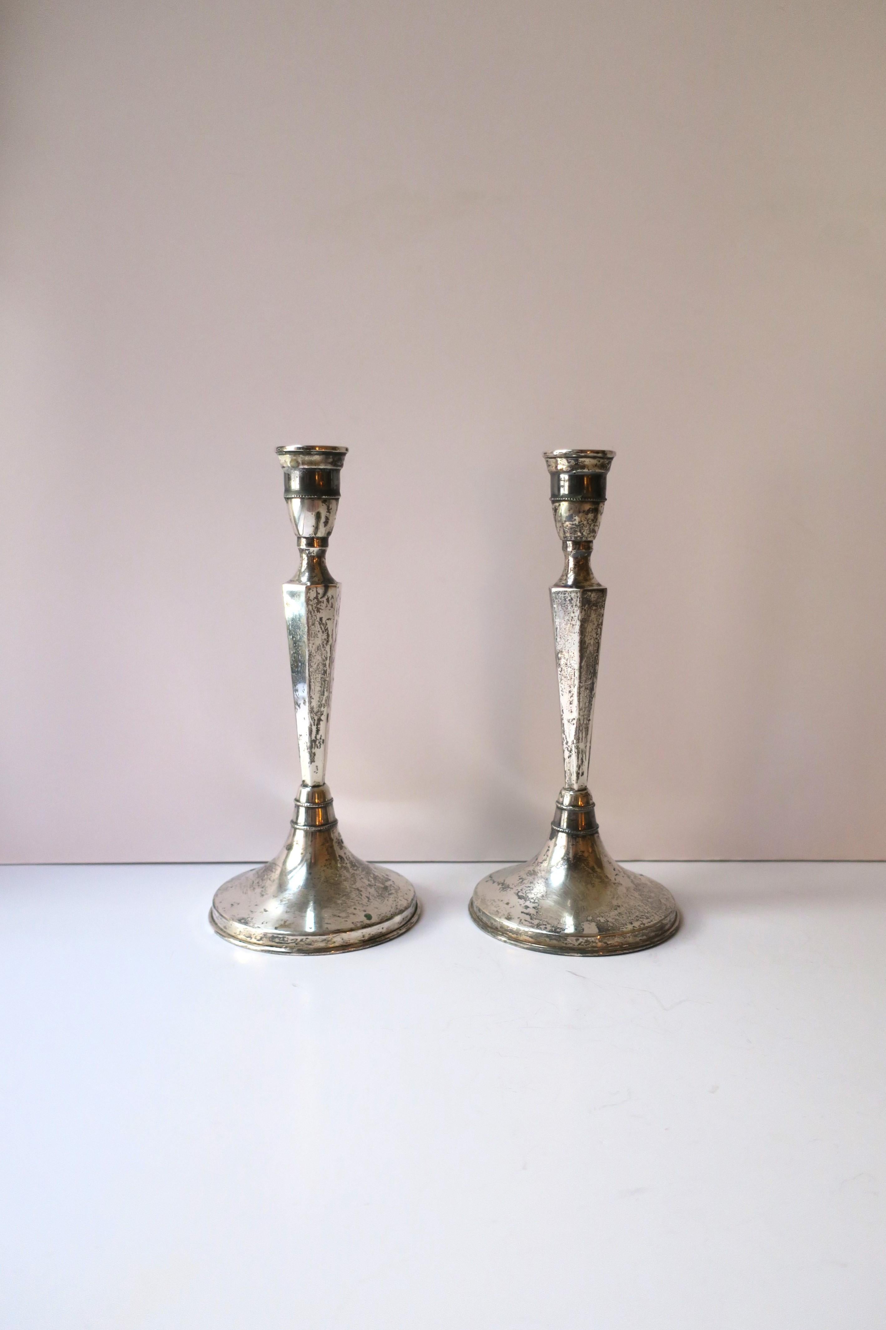 A pair of European continental silver candlesticks holders, circa early-20th century, Europe. Pair, lightweight in nature, have hexagon shape at center stem and tiny beadwork design around at top and bottom. A beautiful set with age and all. Set,