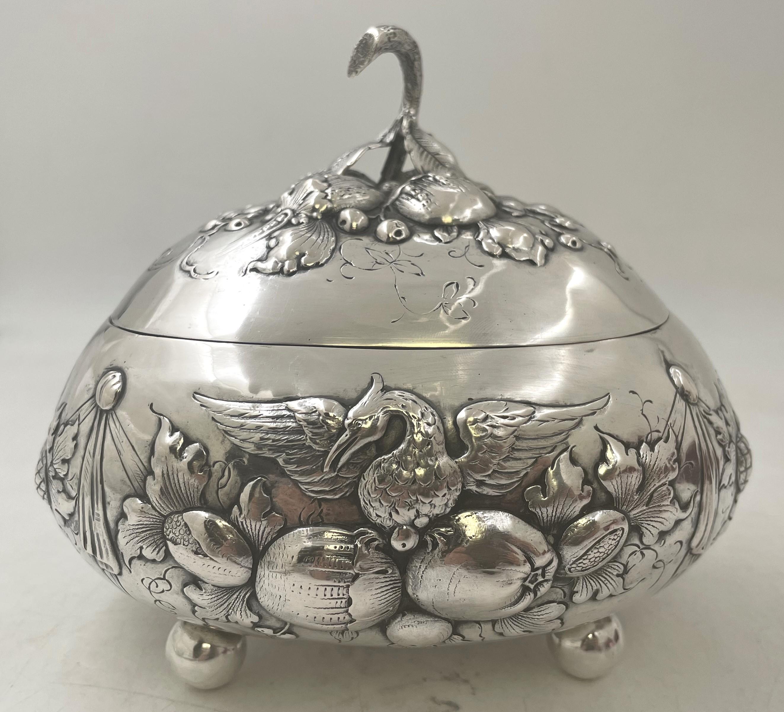 European, continental silver etrog box from the 19th century, adorned with natural motifs and swans. It measures 7'' in depth by 6 1/3'' in height by 5 1/2'' in width, weighs 13 troy ounces, and bears hallmarks as shown.

Please feel free to ask us