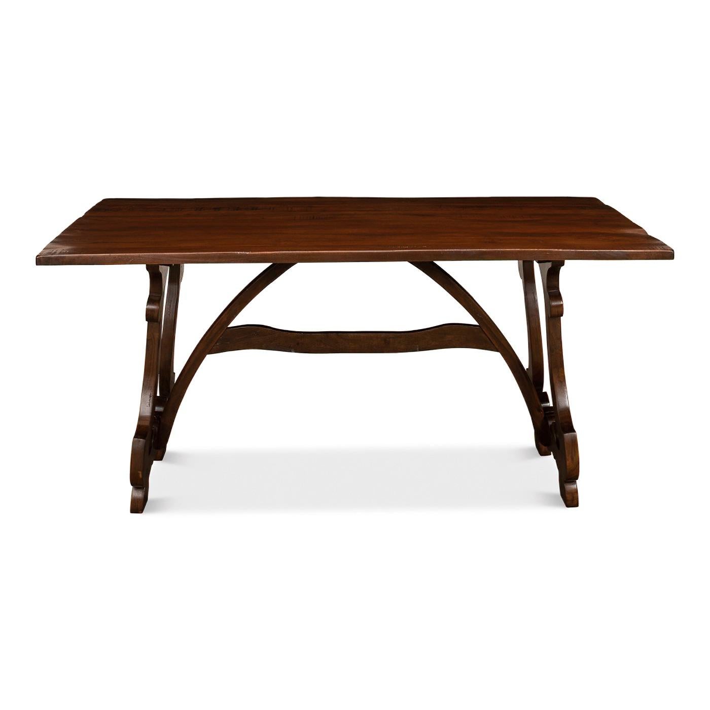 A European country-style dining table with a beautifully carved trestle end base in a rich walnut finish. 

Dimensions: 63
