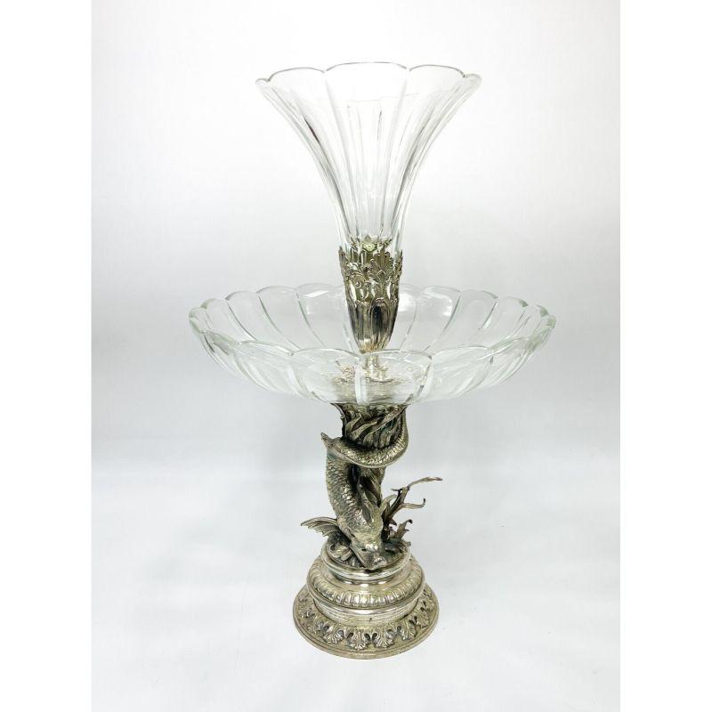 European cut glass and silverplate two tier dolphin formed garniture, circa 1920

Scalloped ribbed fluted glass with a figural dolphin the base stem. Unmarked, but incised 