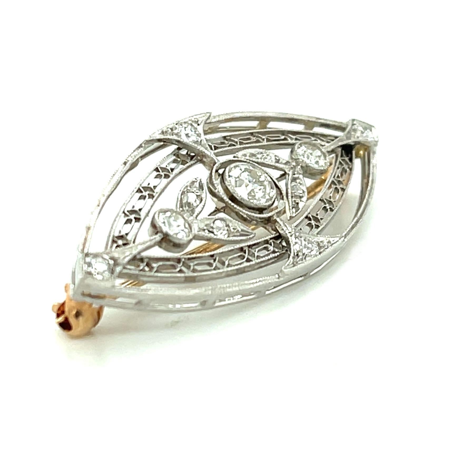 This elegant, leaf-shaped platinum brooch is set with approximately 0.60 carats in diamond rounds and has such a beautifully refined look! The larger European cut diamonds have F-color and VS-clarity* and are bezel set with fine milgrained details.