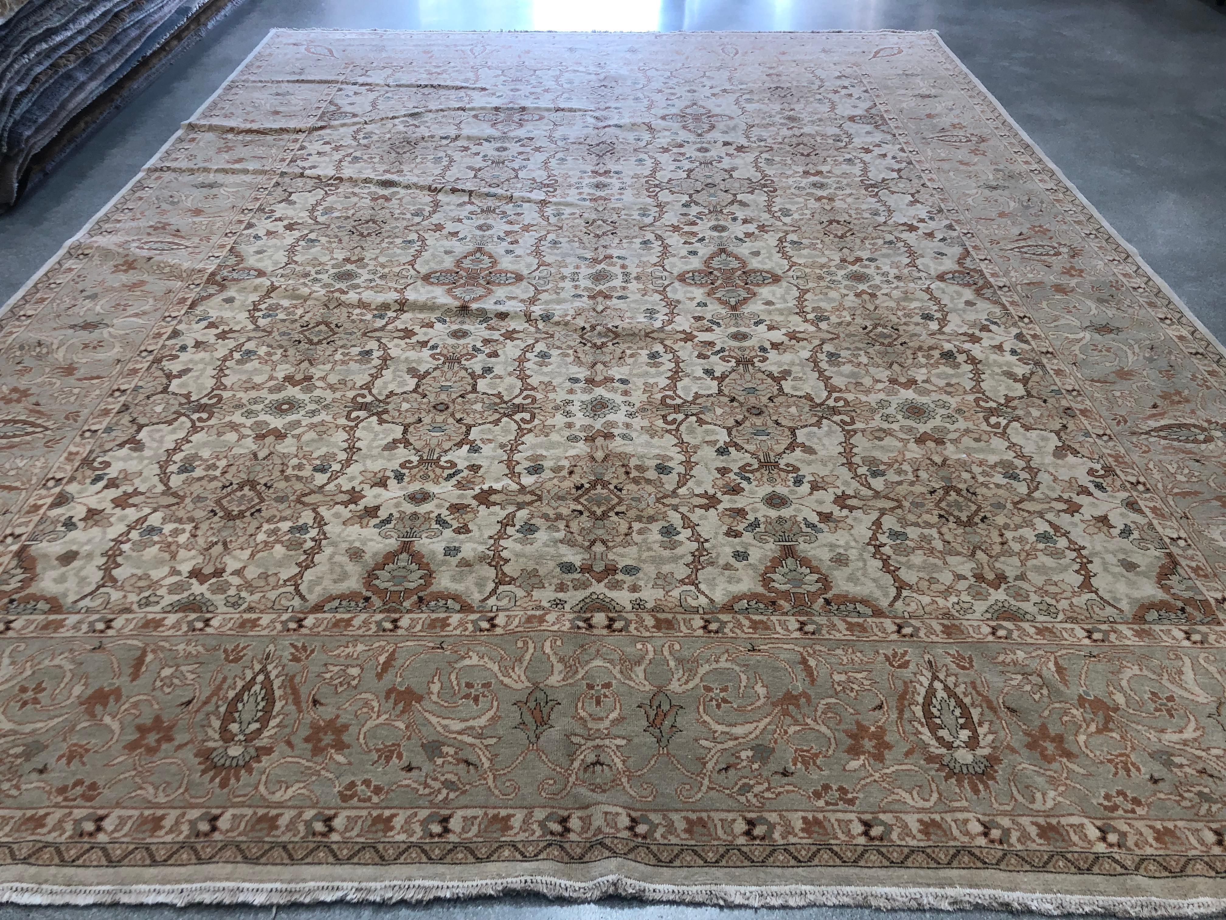 Two design motifs blend together seamlessly in this elegant traditional-style wool area rug from the European Design collection. The large center panel features a jeweled pattern of brown, gold and teal tones against an ivory/beige background while