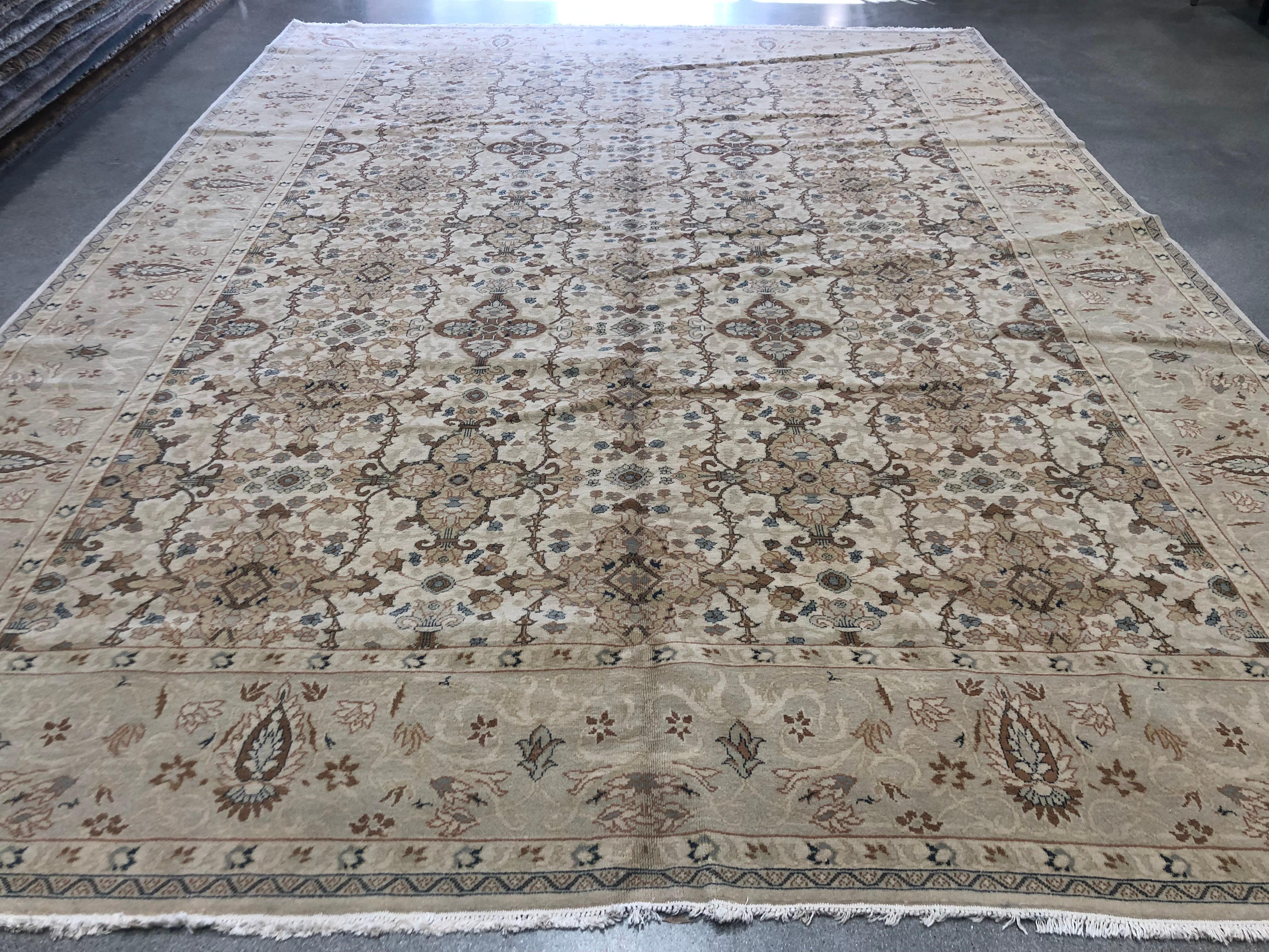 A densely patterned large center panel is surrounded by a light border with floral motif in this charming wool area rug from the European Design collection. Warm beige, brown and gold tones predominate making for a piece that can blend easily into a