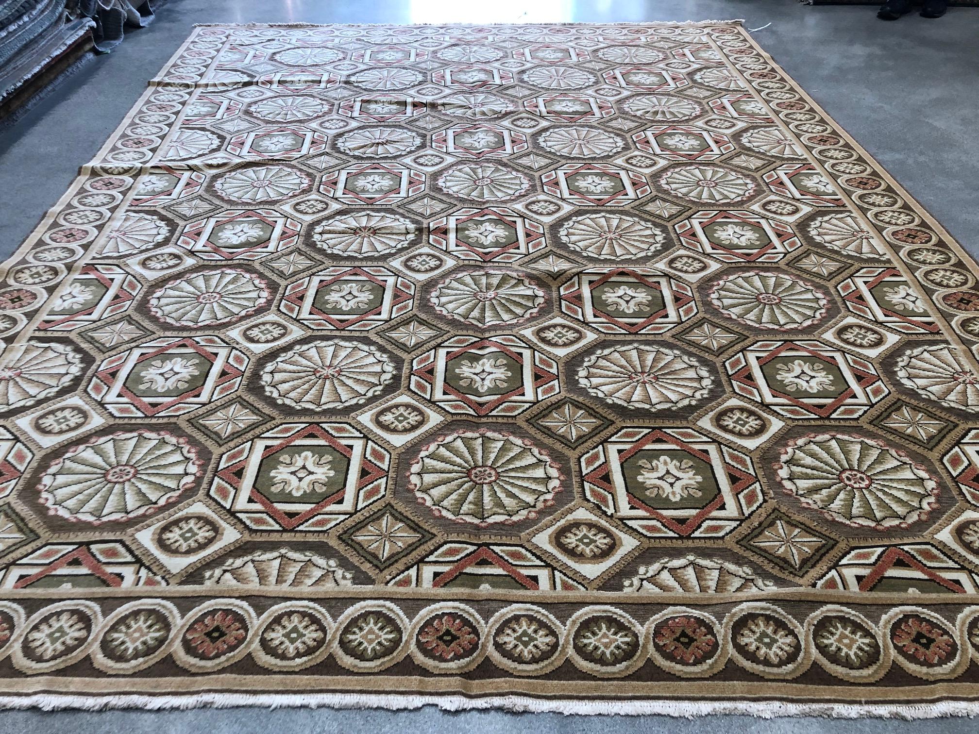 The eye-catching geometric all-over pattern within a center panel/frame traditional layout makes this European Design rug stand out. Brown, green, ivory, rust and taupe coloring pairs well with wood and metallic finishes in the living room, dining