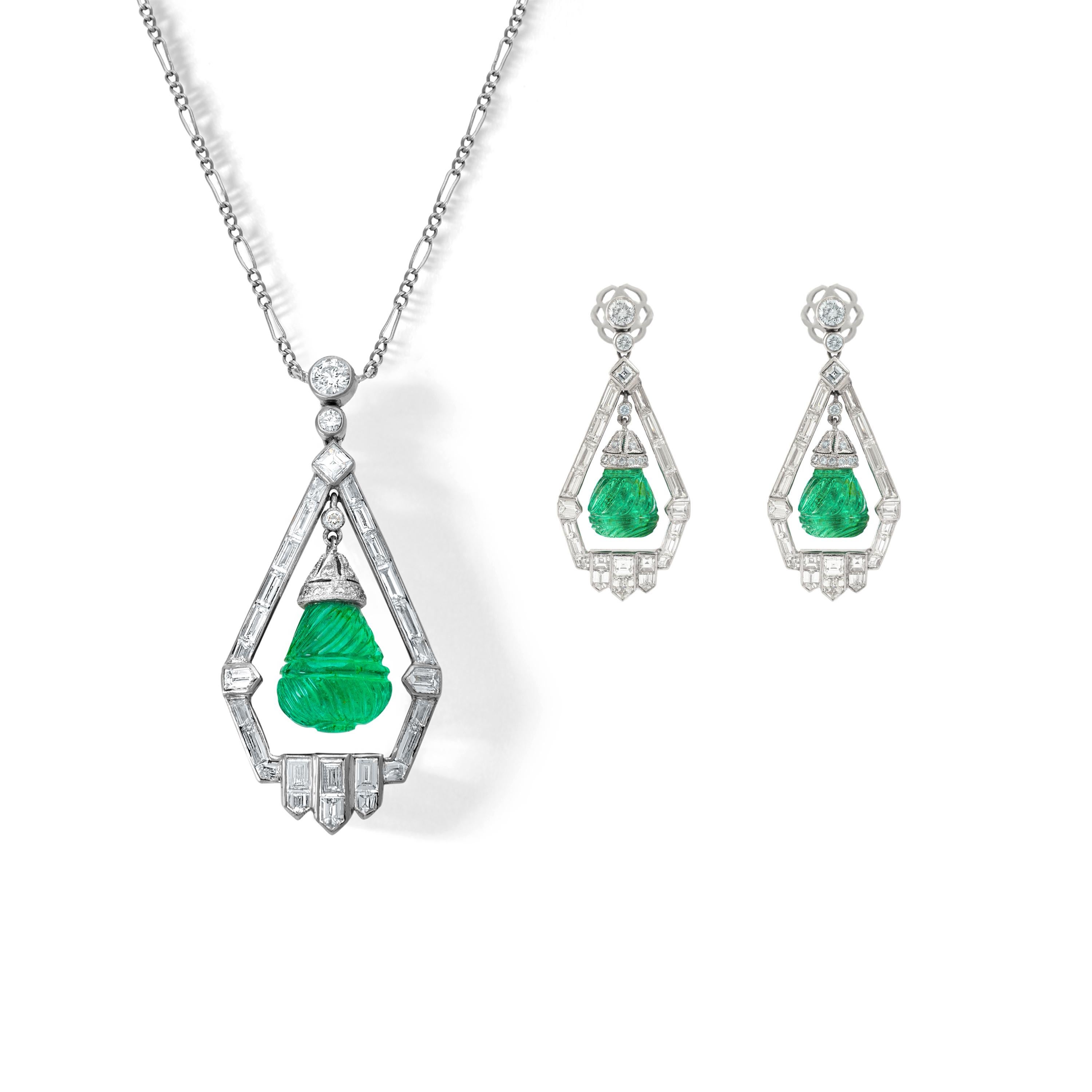 Art Deco design Demi-Parure including Ear Pendants and a Pendant in Platinum and Diamond (baguette cut and round cut) holding engraved Emeralds.

Earrings Length: 1.58 inch (4.00 centimeters)
Earrings total weight: 12.92 grams.

Pendant length: 1.77