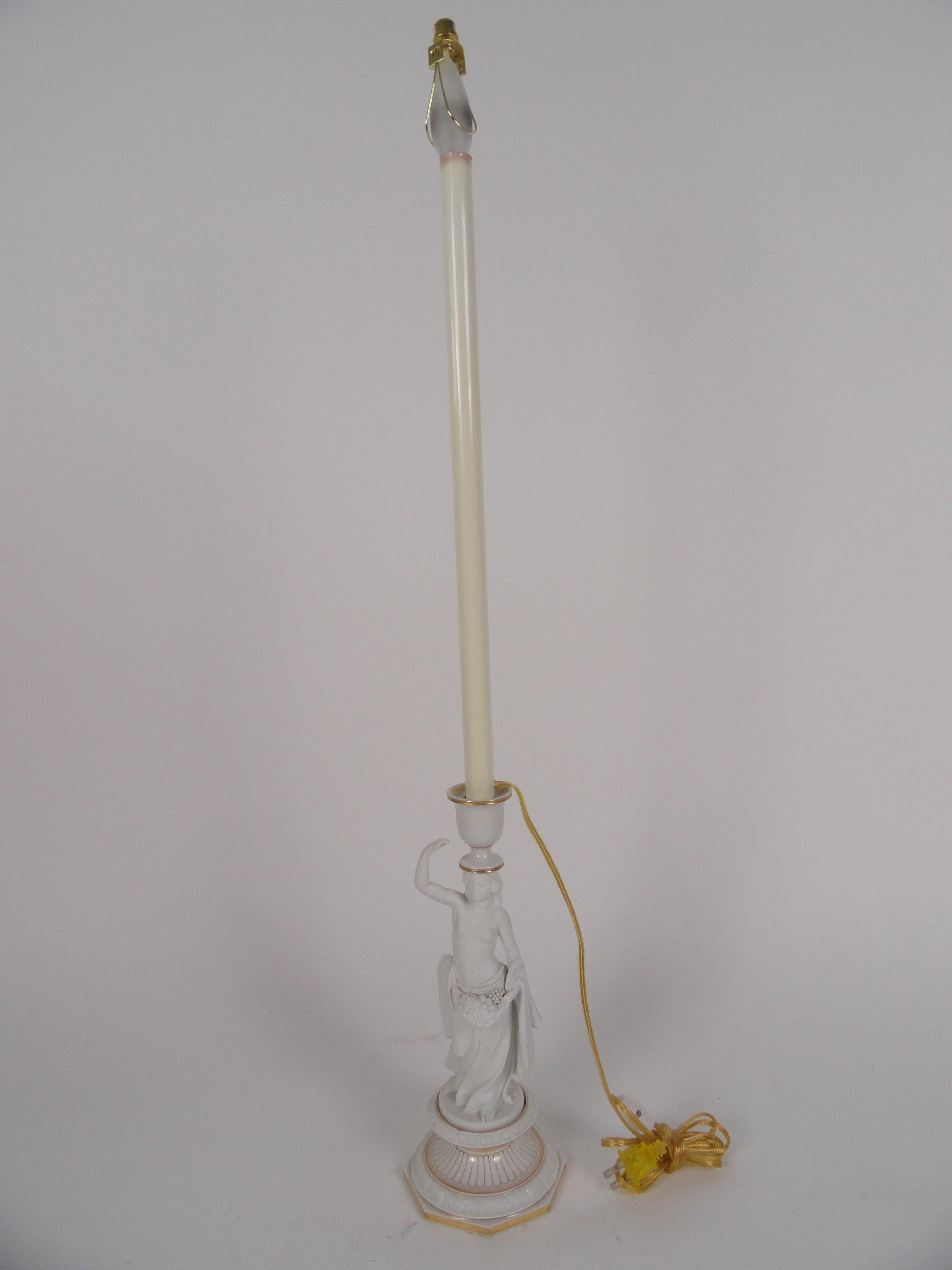 White bisque female figure lamp. Gold leaf detail. Markings on bottom. Newly wired with inline switch.
Measures: Height is 13